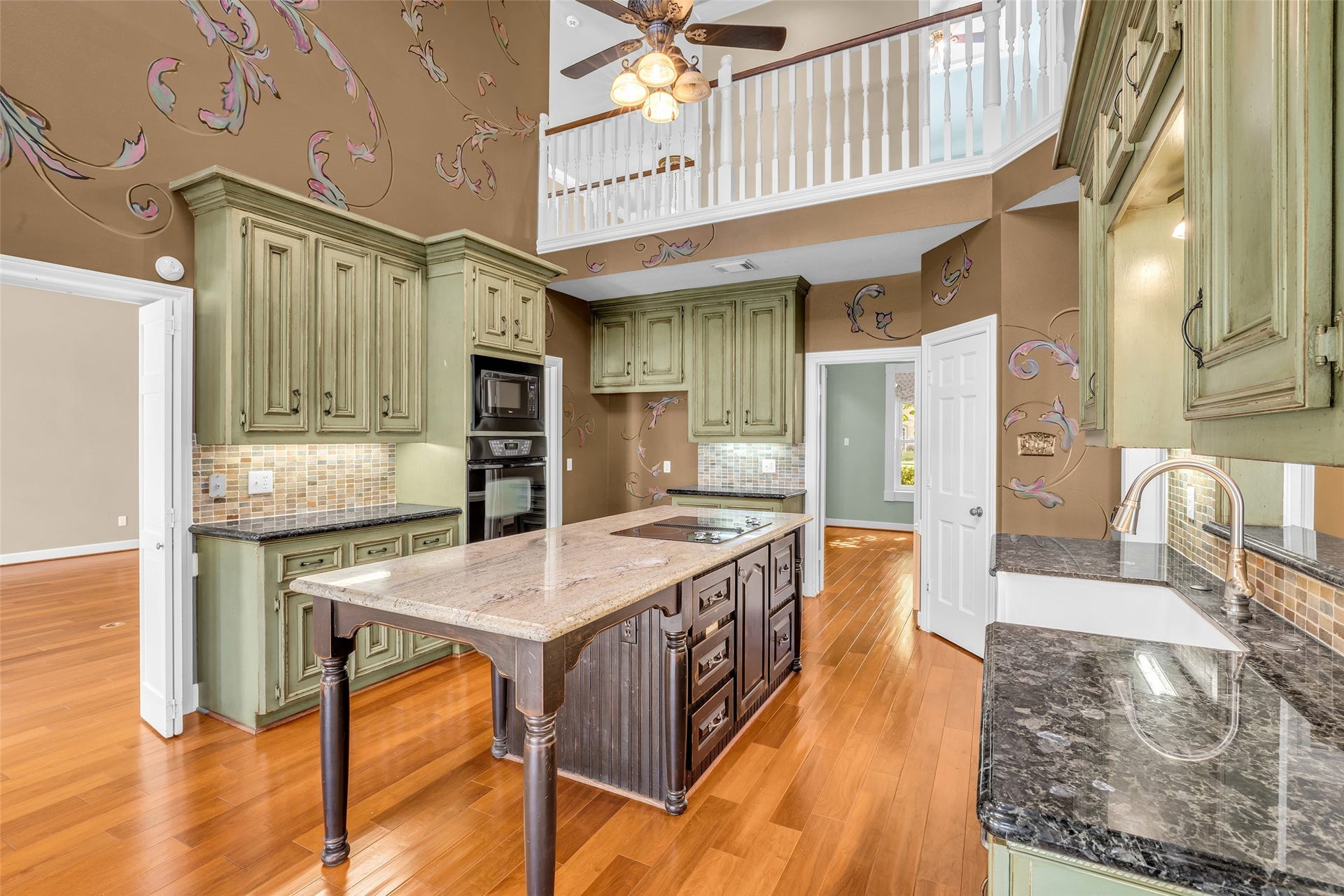 5907 Rocky Brook Drive, Houston, TX 77345 Two-story kitchen with large center island, breakfast area, and skylights.