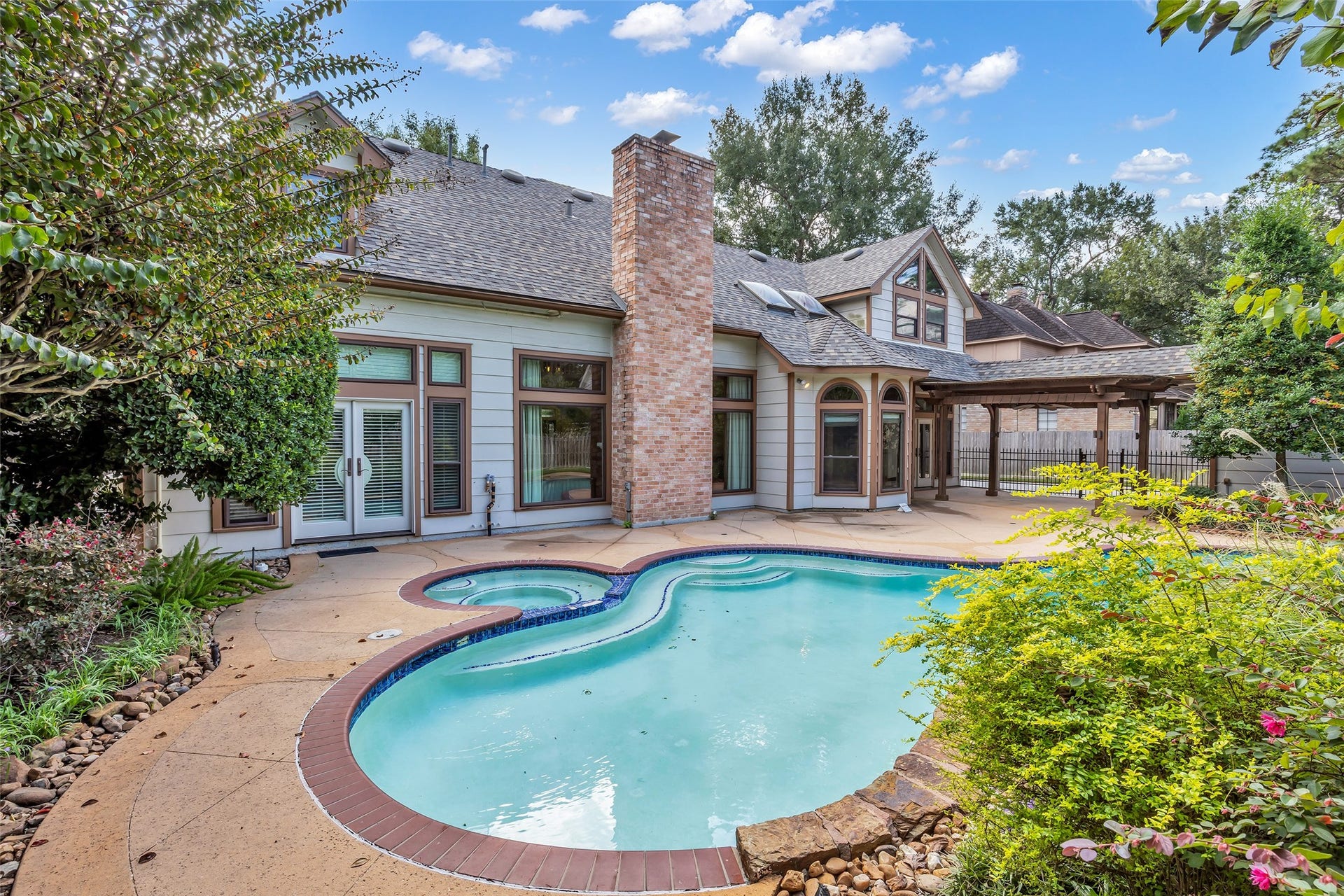 5907 Rocky Brook Drive, Houston, TX 77345 Private pool surrounded by mature landscaping and an expansive patio.