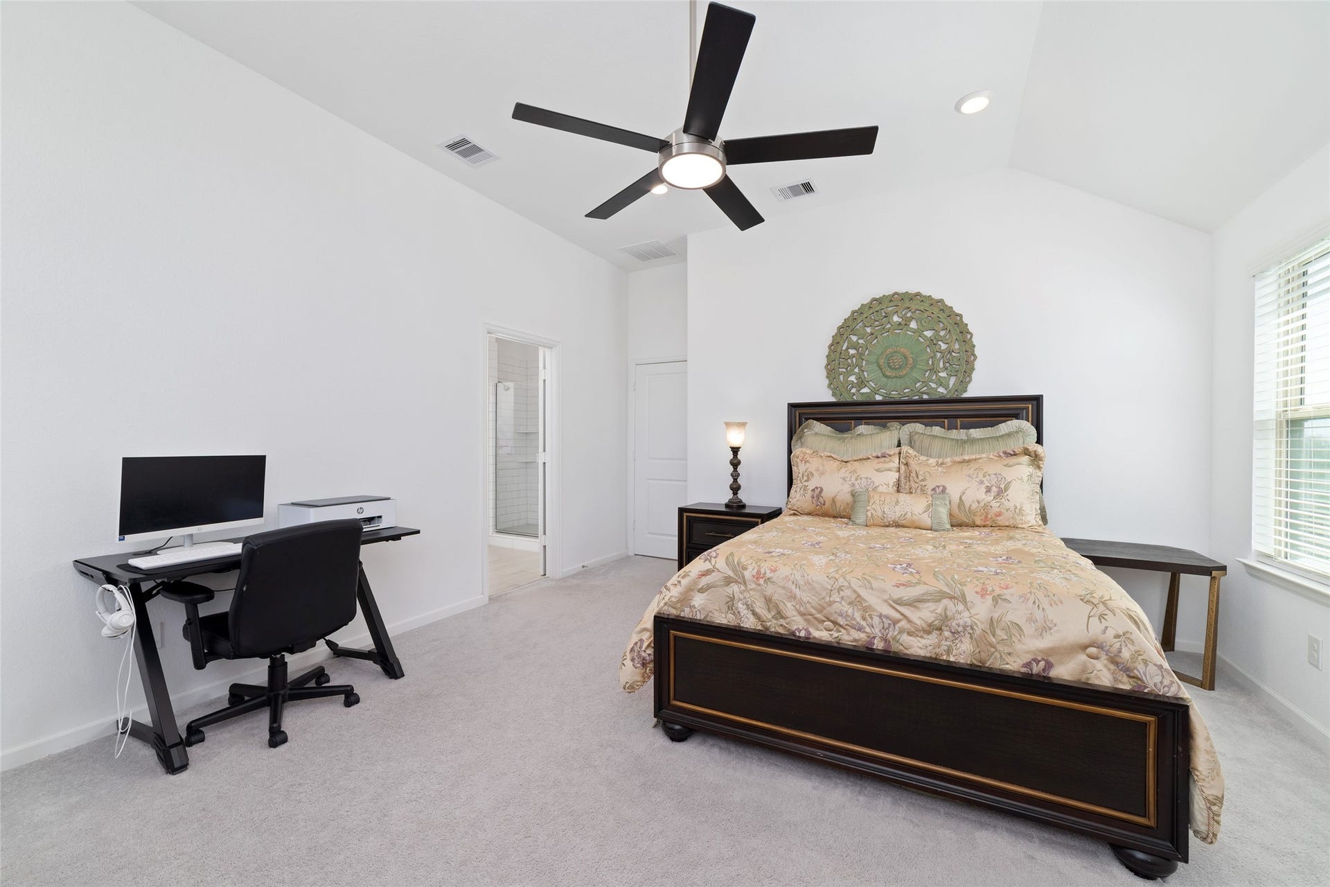 5715 Foggy Vine Court, Fulshear, TX 77441 The spacious primary bedroom features plush carpeting, a ceiling fan, neutral walls, and ample room for a king-sized bed and additional furnishings.