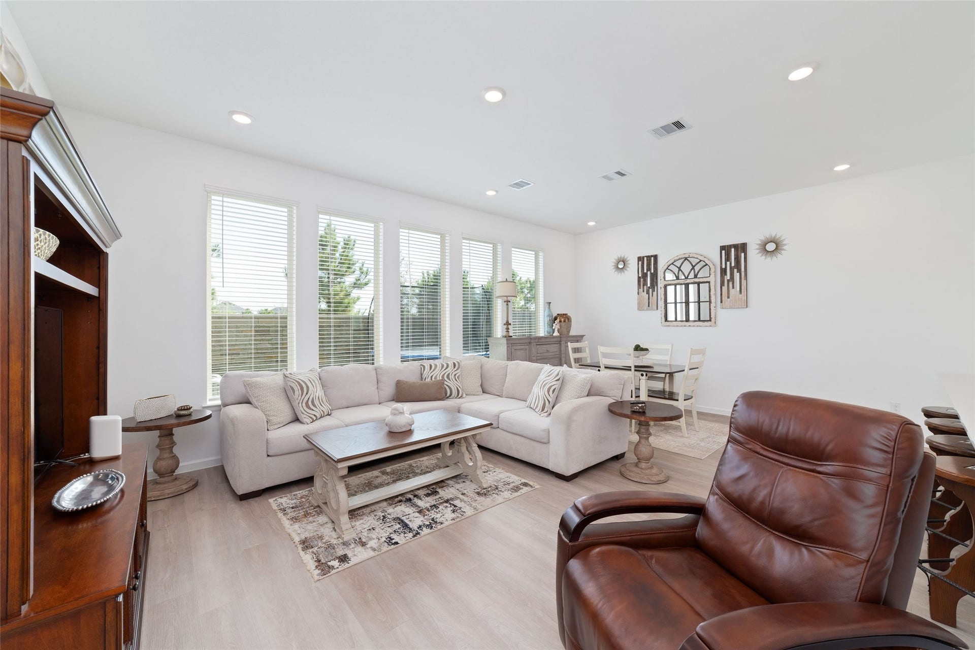 5715 Foggy Vine Court, Fulshear, TX 77441 Large windows fill the family room with natural light, while the open floor plan allows for easy interaction between the living, dining, and kitchen spaces.