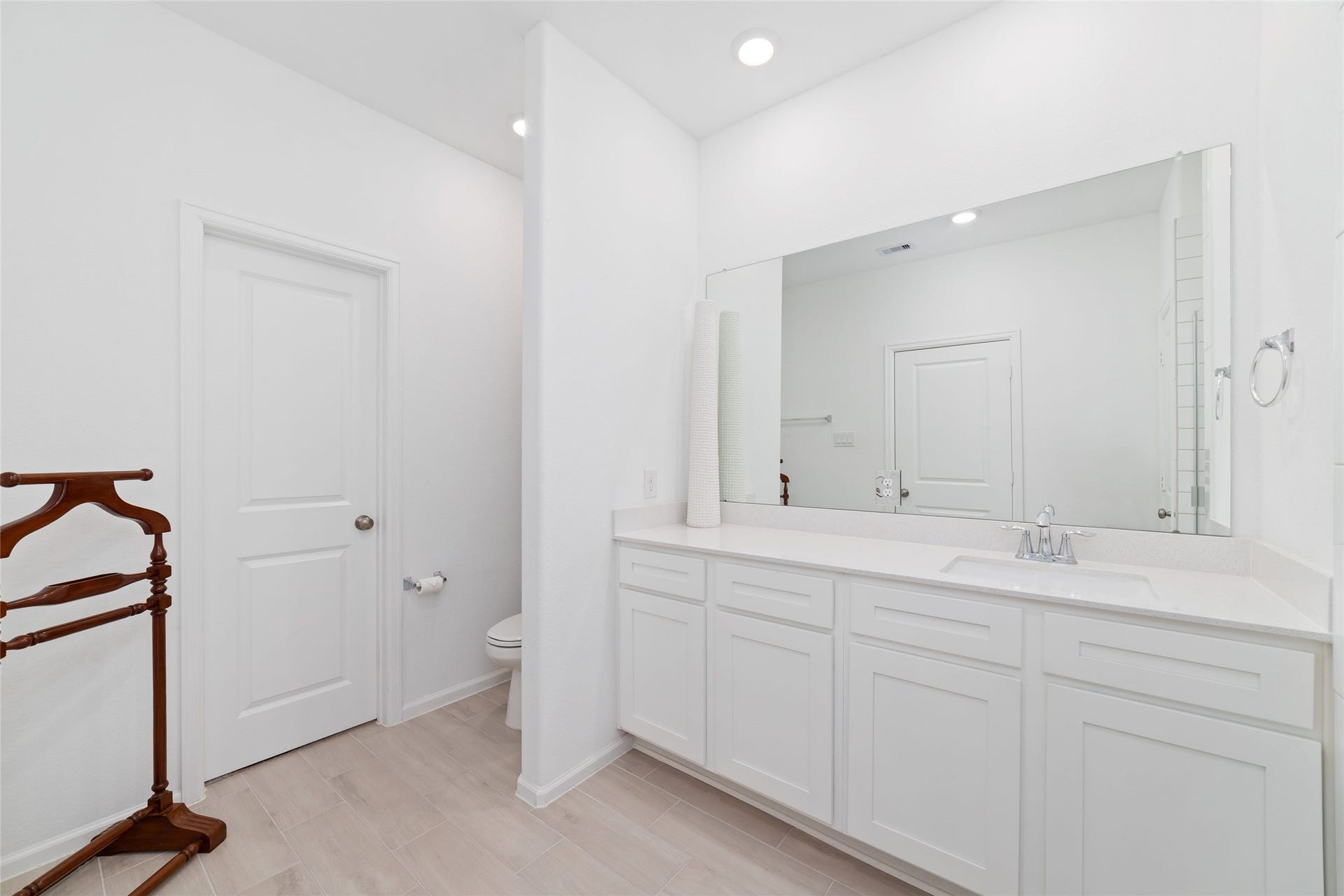 5715 Foggy Vine Court, Fulshear, TX 77441 Another view of the primary bathroom highlights the vanity area, neutral finishes, and convenient layout.