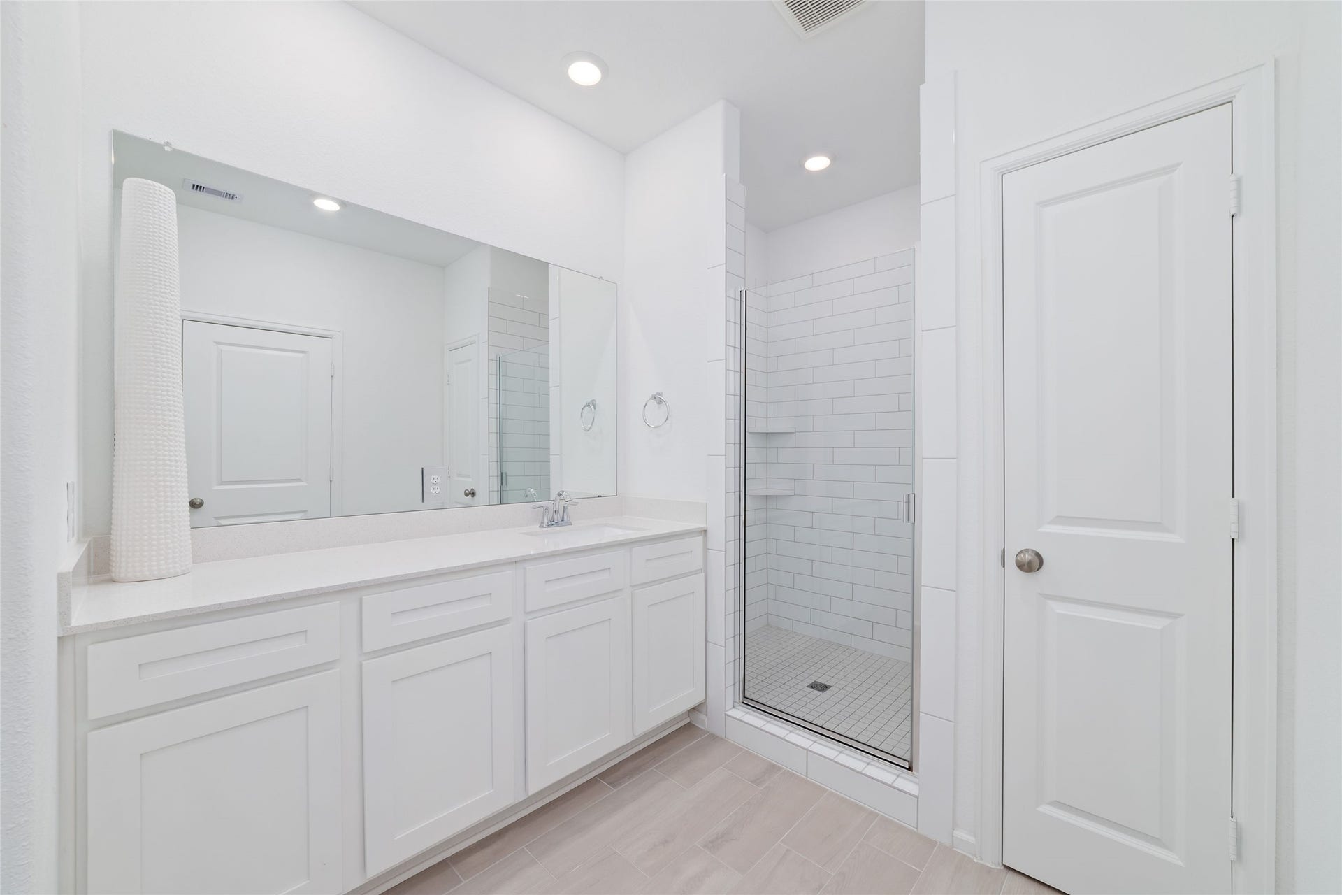 5715 Foggy Vine Court, Fulshear, TX 77441 The primary bathroom features a spacious vanity with white cabinetry, generous counter space, and a separate walk-in shower.