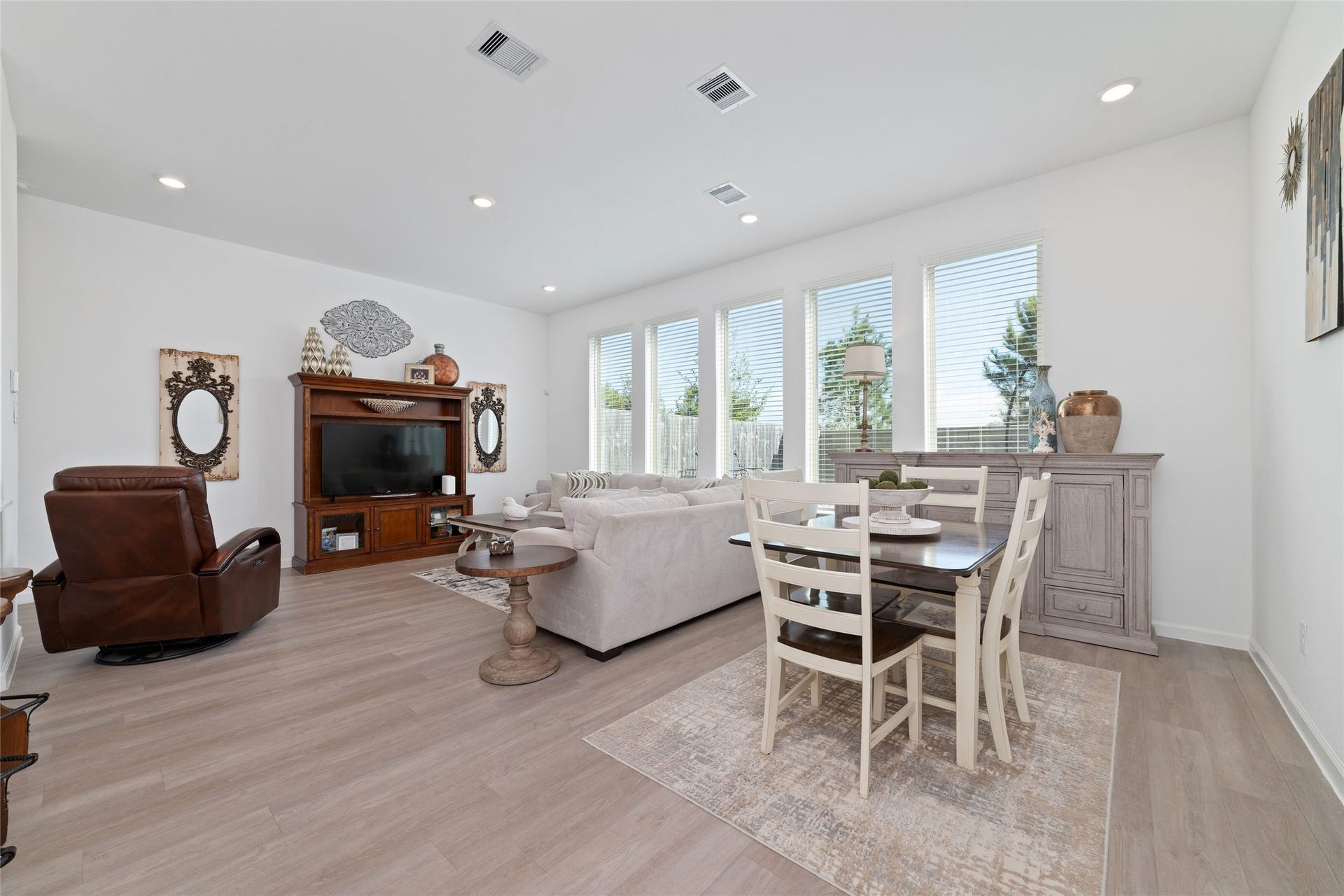 5715 Foggy Vine Court, Fulshear, TX 77441 Enjoy a spacious family room featuring large windows, recessed lighting, neutral finishes, and an open layout designed for comfortable everyday living.