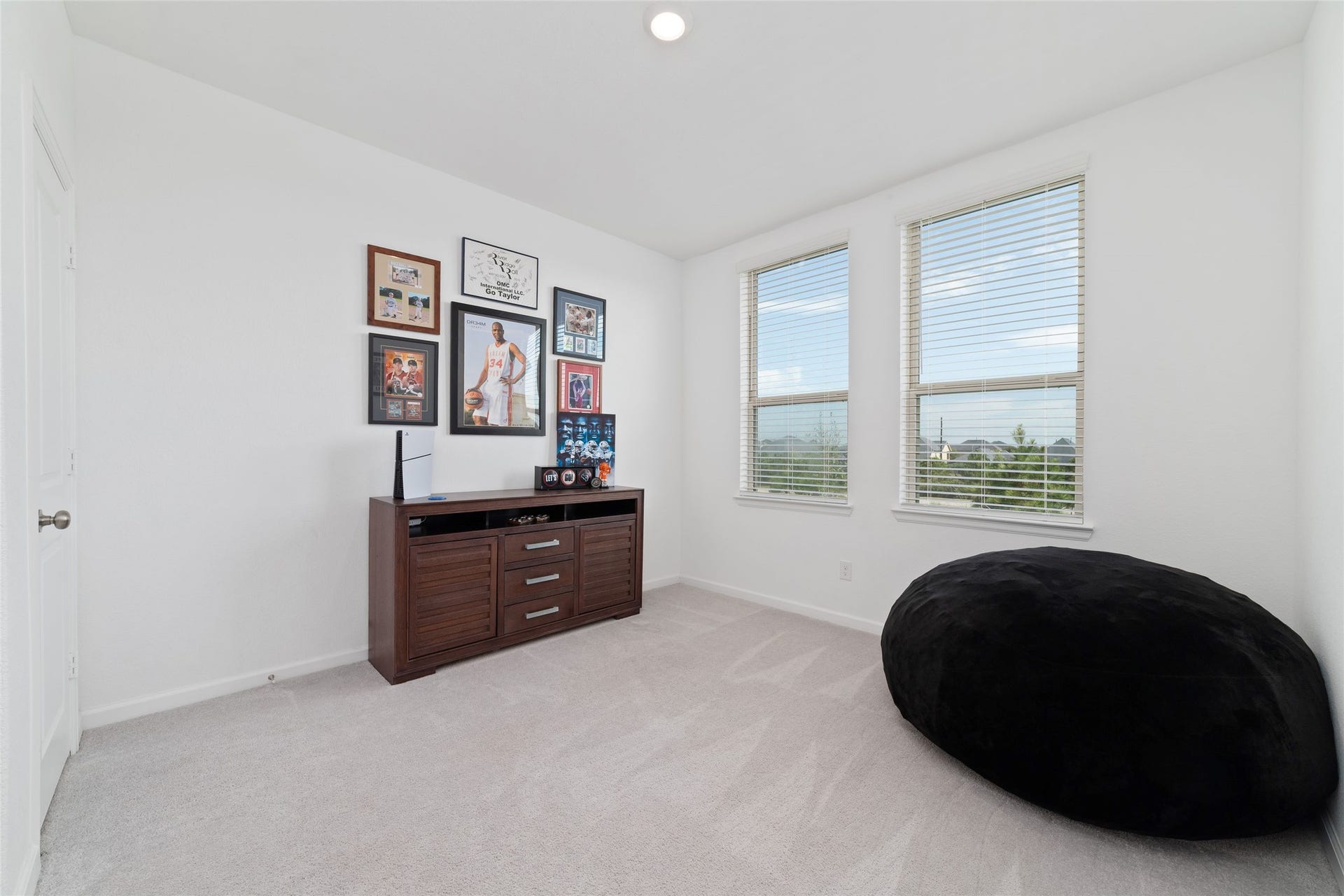 5715 Foggy Vine Court, Fulshear, TX 77441 The additional secondary bedroom offers natural light, soft carpeting, and flexible space to accommodate a variety of needs.