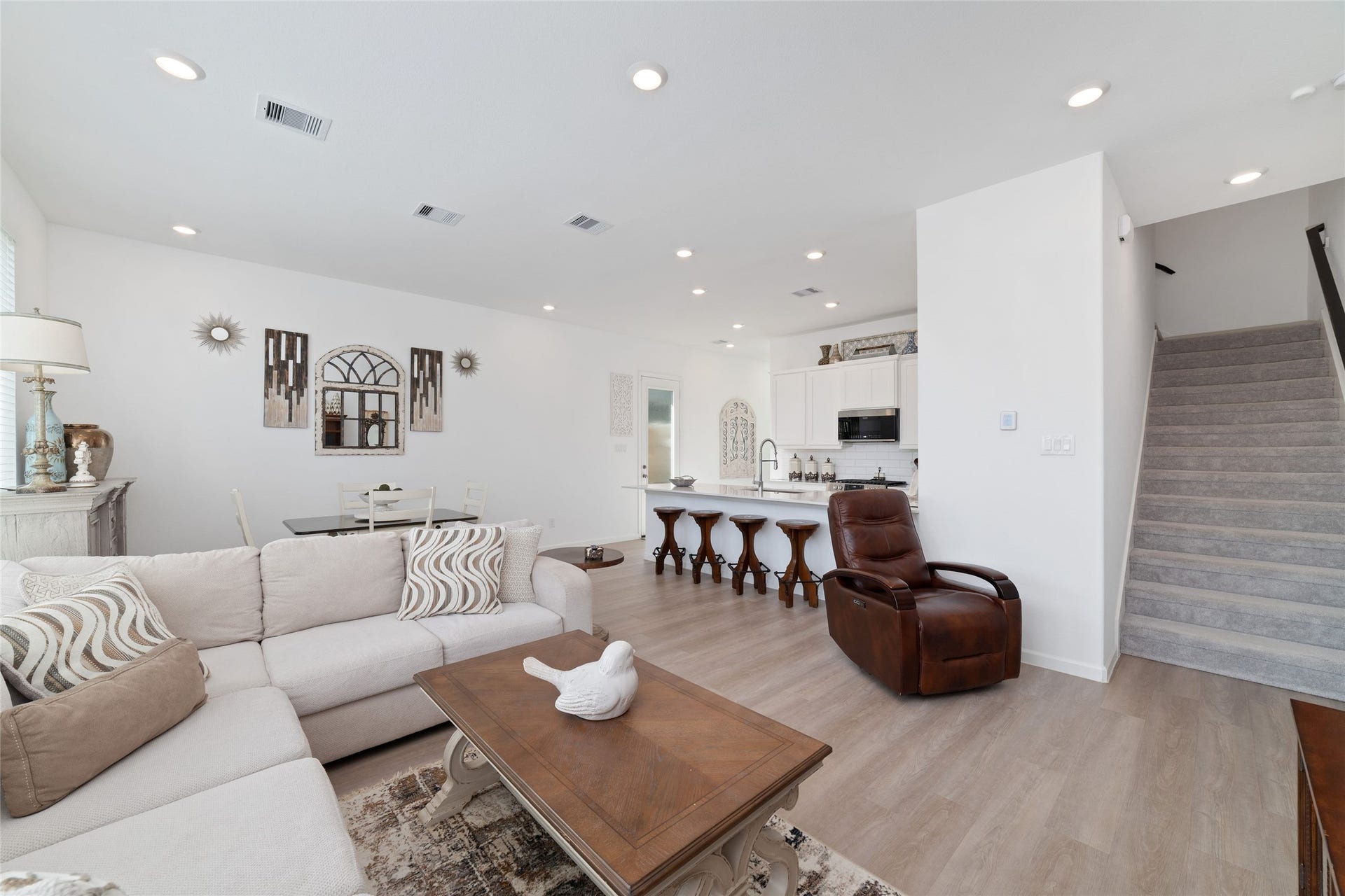 5715 Foggy Vine Court, Fulshear, TX 77441 The thoughtfully designed main level offers a seamless flow between gathering spaces, with a staircase leading to the upstairs bedrooms and game room.