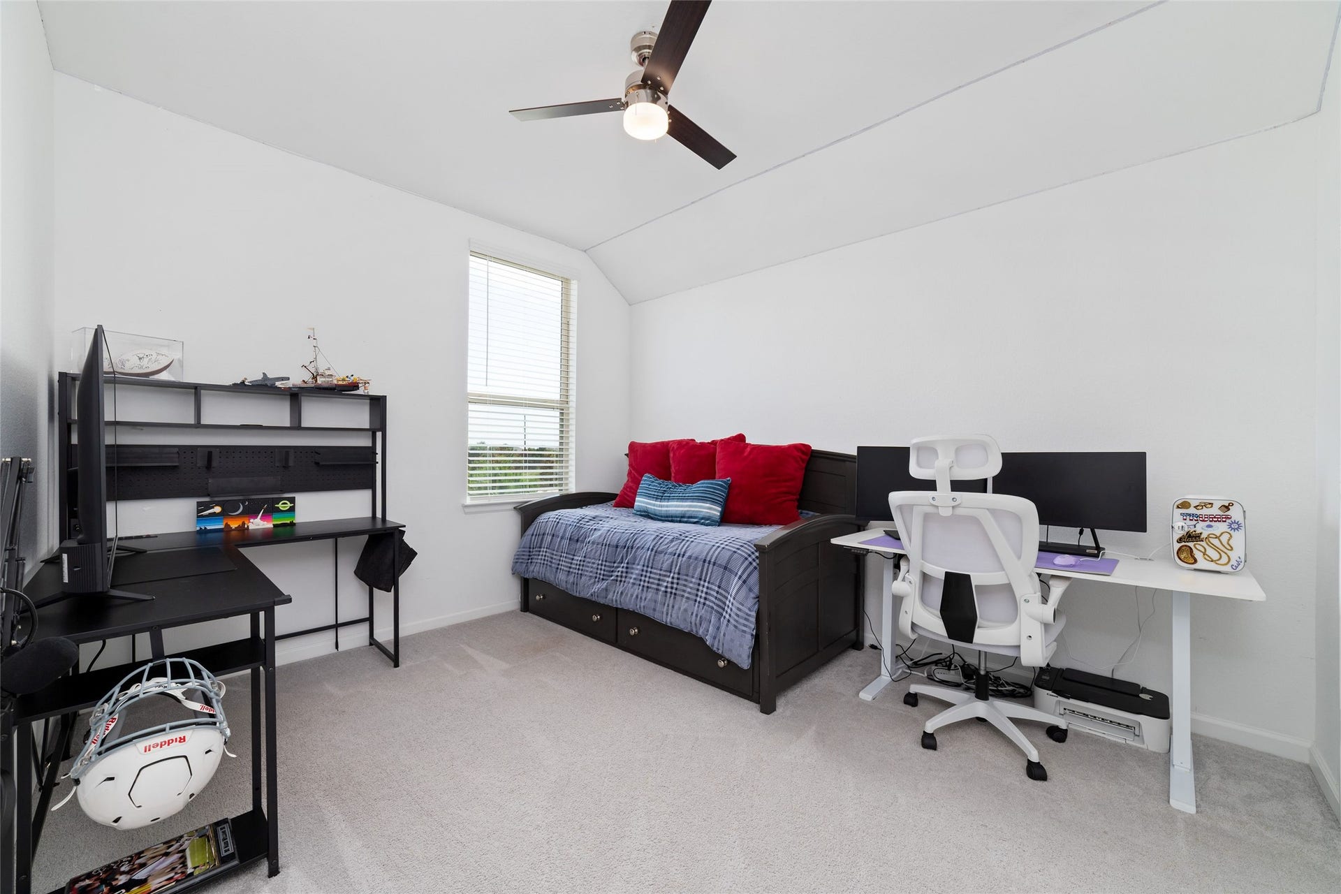 5715 Foggy Vine Court, Fulshear, TX 77441 A secondary bedroom features plush carpeting, neutral finishes, and a large window, offering a comfortable space for family members or guests.