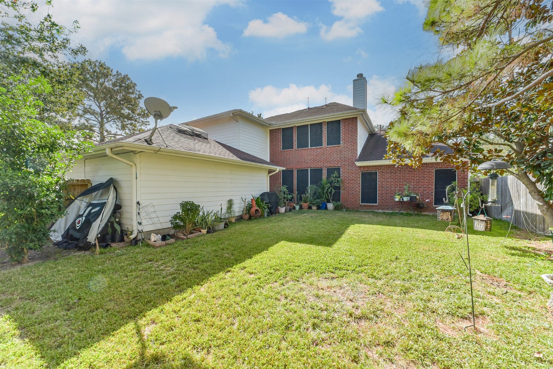18402 Spinner Court Drive, Humble, TX 77346 The home is built with brick on all four sides, and the back is fitted with a solar screen.