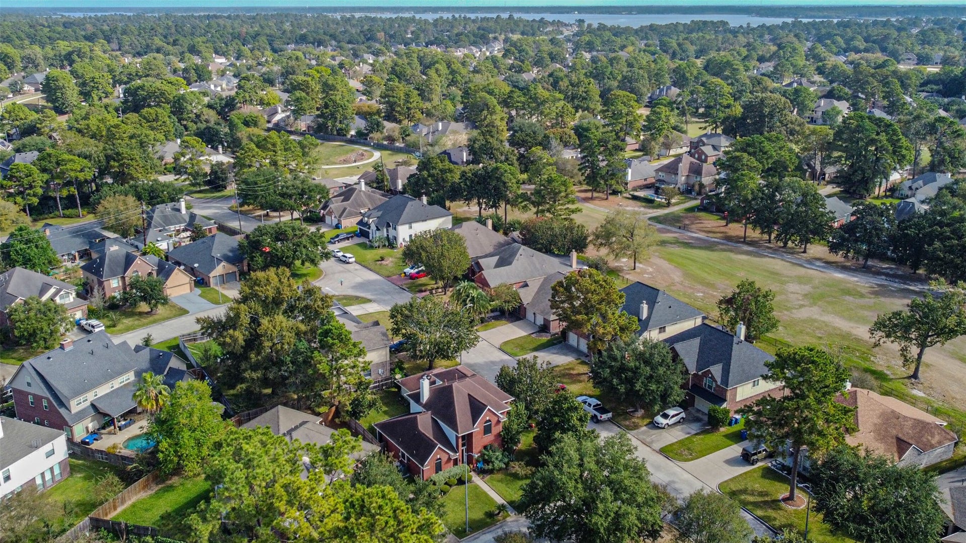 18402 Spinner Court Drive, Humble, TX 77346 Aerial view of the home, with Lake Houston in the background.