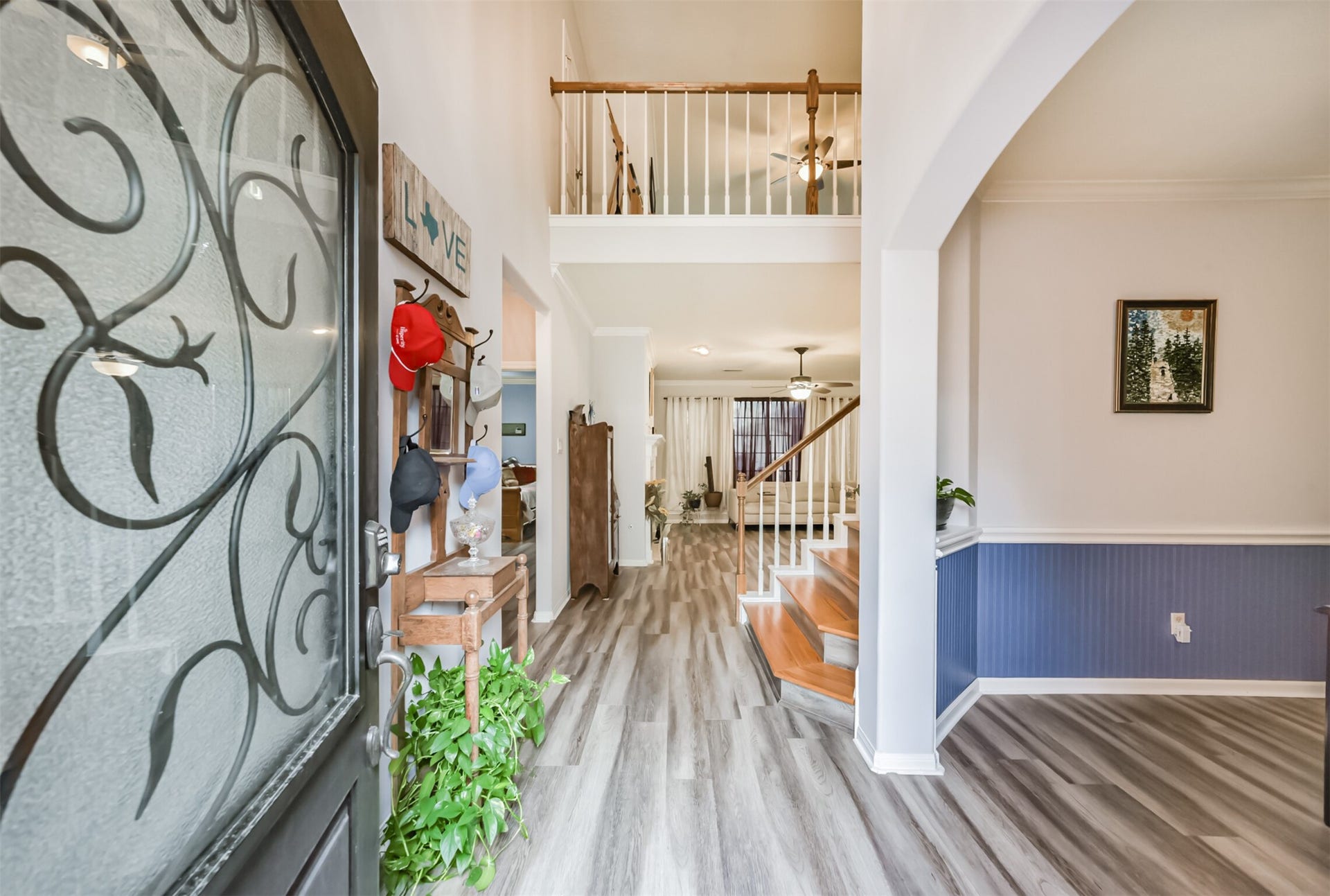 18402 Spinner Court Drive, Humble, TX 77346 A soaring two-story foyer welcomes you with extensive wood-look vinyl plank flooring, while an elegant arched formal dining room sits just to the right.