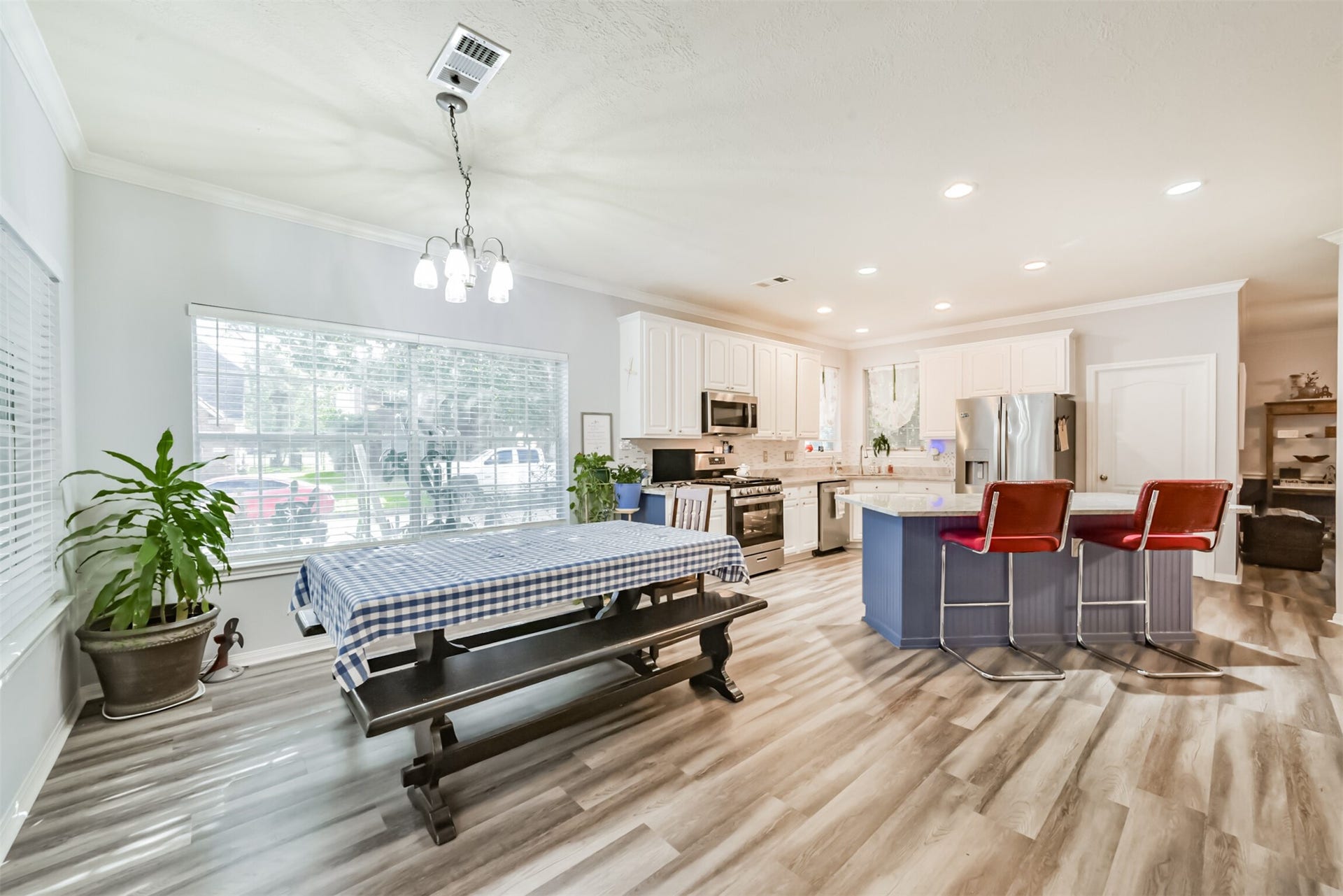 18402 Spinner Court Drive, Humble, TX 77346 The spacious breakfast room, framed by two sets of windows, is ideal for informal dining. The island kitchen, complete with a breakfast bar, can also be viewed from here.