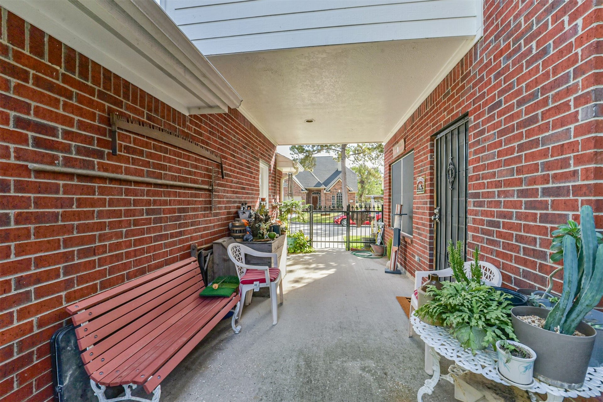 18402 Spinner Court Drive, Humble, TX 77346 Relax in the cool shade of the covered breezeway, a perfect spot for unwinding or entertaining guests.