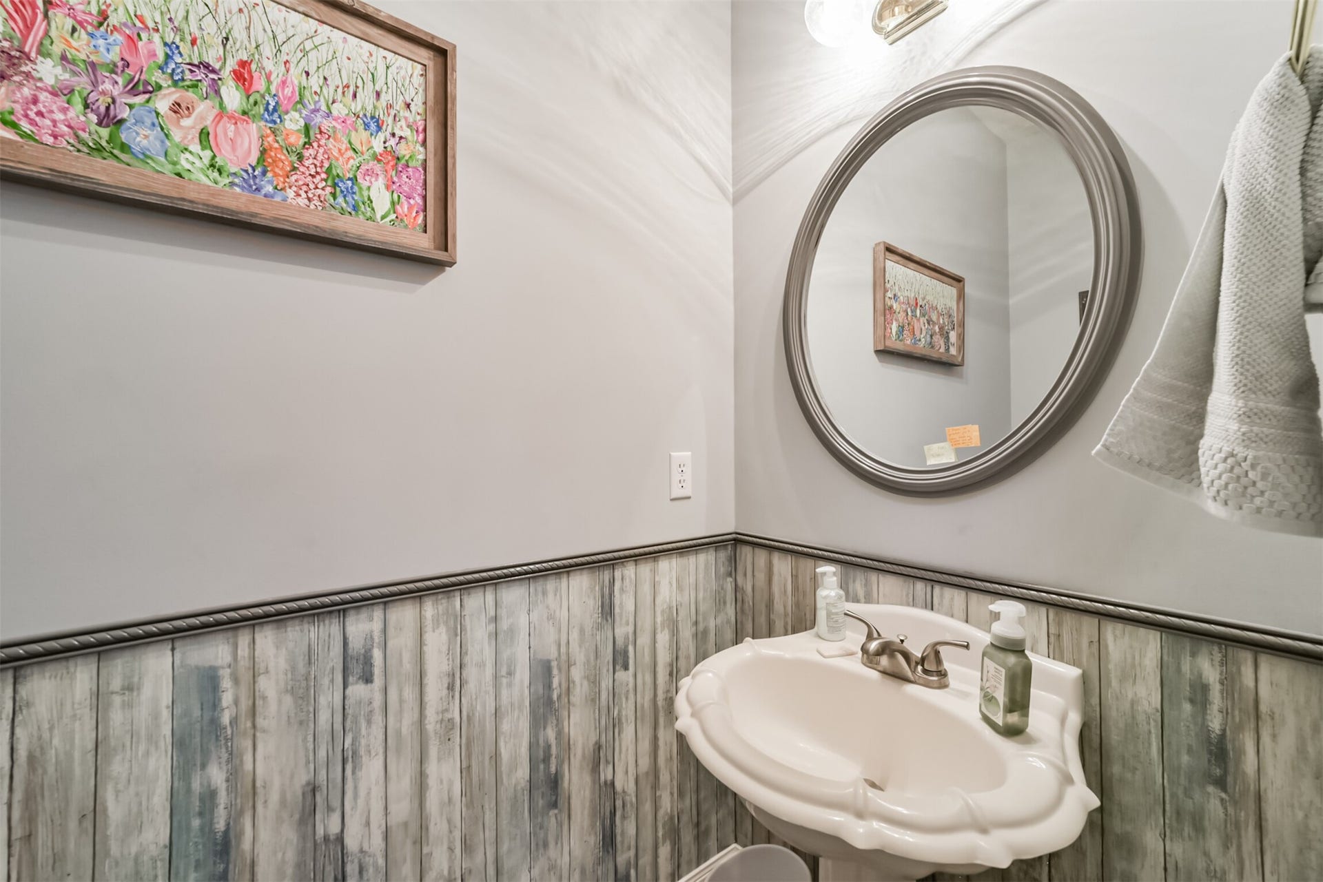 18402 Spinner Court Drive, Humble, TX 77346 The downstairs half bath features a pedestal sink and Beadboard wall accents.