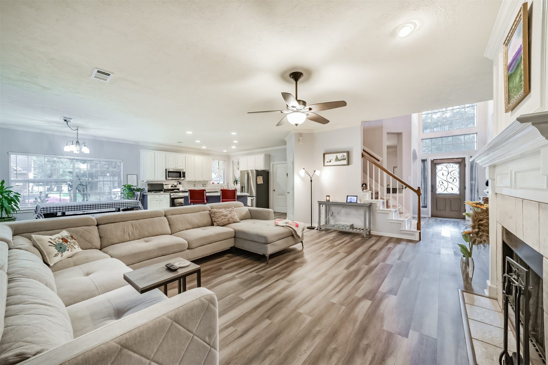 18402 Spinner Court Drive, Humble, TX 77346 A view of the open-concept home from the family room, softly lit by ambient lighting.