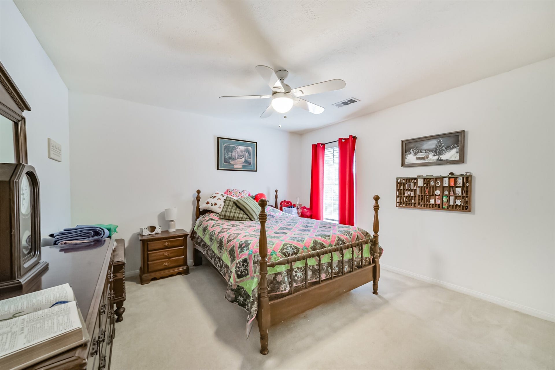 18402 Spinner Court Drive, Humble, TX 77346 Upstairs bedroom 2 features a ceiling fan, a light fixture, and window blinds with curtains.