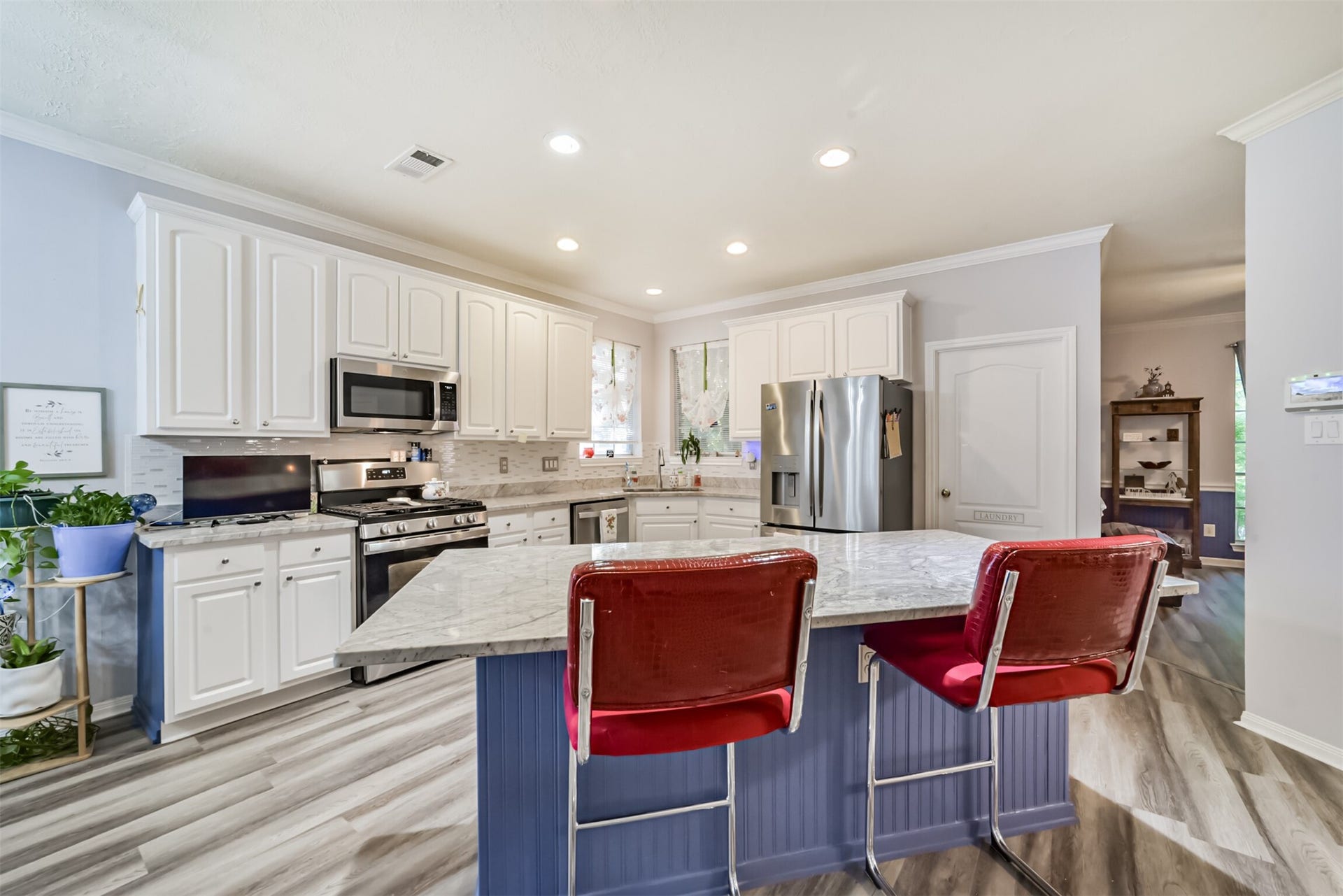 18402 Spinner Court Drive, Humble, TX 77346 A center island with a breakfast bar and granite countertops, complemented by recessed lighting.