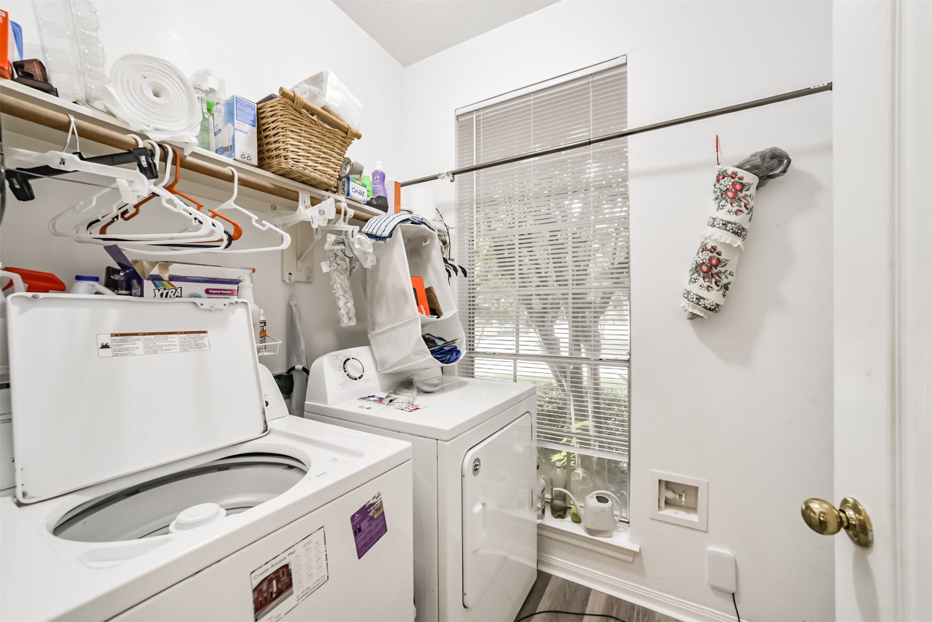 18402 Spinner Court Drive, Humble, TX 77346 A laundry room with a storage shelf, a wooden drying rod, and a window.