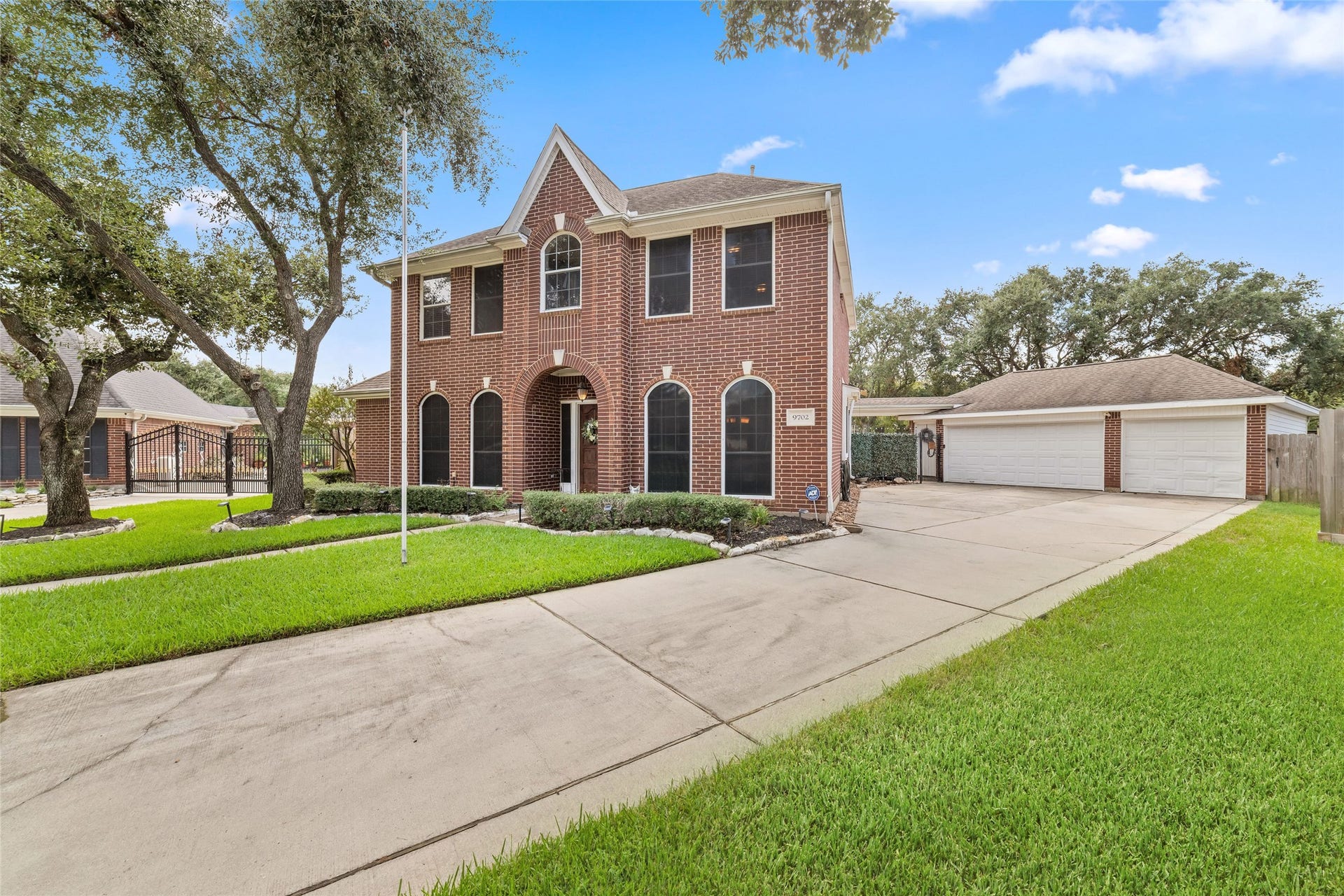 Extended driveway, three car garage configuration, and spacious cul-de-sac setting.