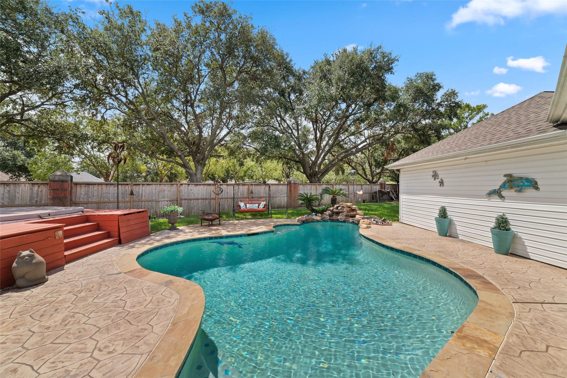 Private pool surrounded by stamped-concrete decking with plenty of space for outdoor seating.