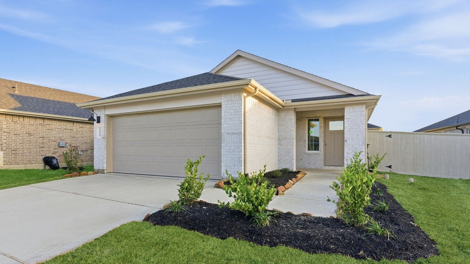 3413 Wild Mustang Street, League City, TX 77511 Newly built single story home with traditional architecture, a double garage, and landscaped front yard.
