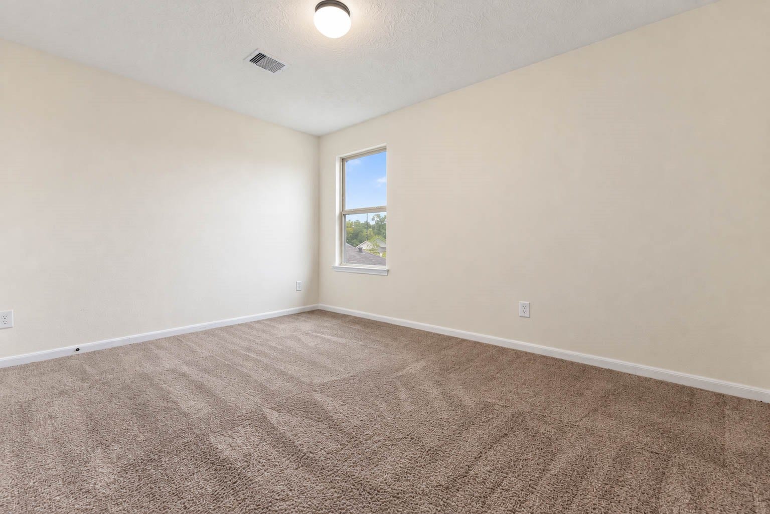 6131 Morning Fern Lane, Humble, TX 77338 This generously sized secondary bedroom offers plush carpeting, a soothing neutral color palette, & a large window that welcomes natural light.