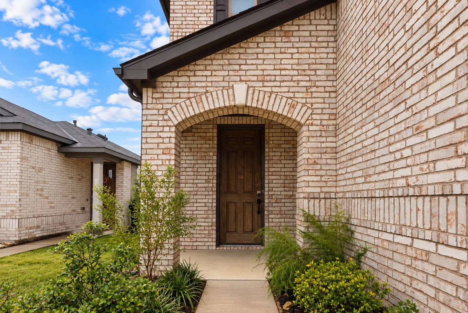 6131 Morning Fern Lane, Humble, TX 77338 Showcasing timeless architectural charm, the home's striking brick faade, elegant arched entryway, & beautifully manicured landscaping create exceptional curb appeal. A welcoming covered front porch adds the perfect finishing touch, making a stunning first impression!