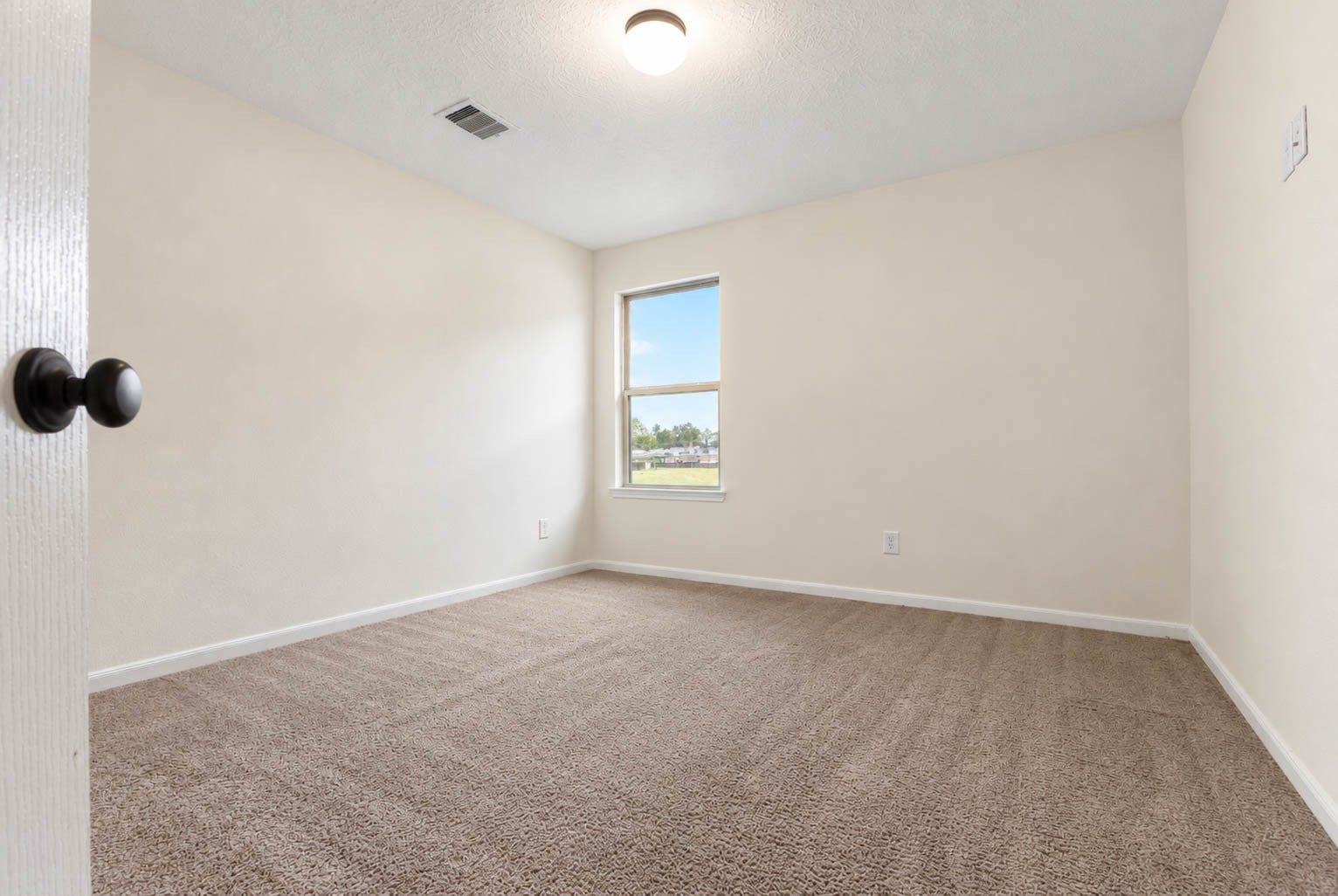 6131 Morning Fern Lane, Humble, TX 77338 This final secondary bedroom offers plush carpeting, neutral finishes, & a large window that fills the space with natural light.