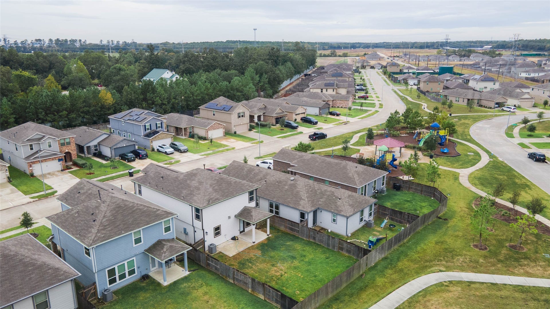 6131 Morning Fern Lane, Humble, TX 77338 Location is everything! This aerial view highlights the home's prime proximity to the neighborhood playground, which features vibrant play structures & shaded seating areas.