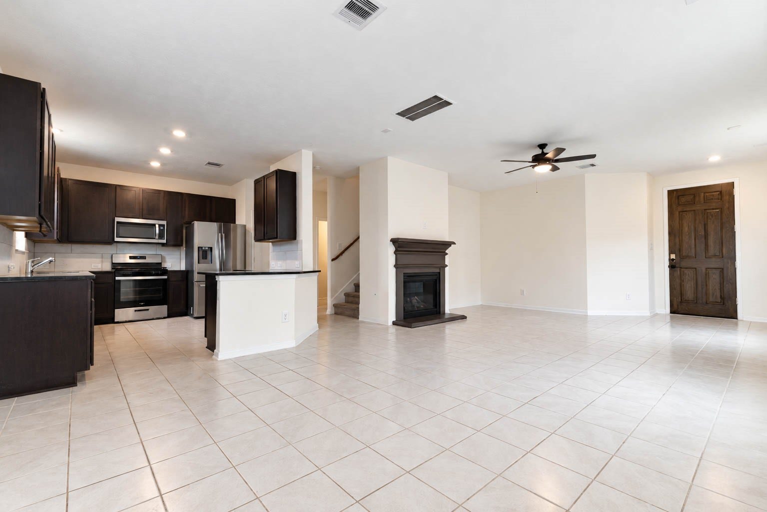 6131 Morning Fern Lane, Humble, TX 77338 The open-concept floor plan connects the dining area with the beautifully appointed kitchen & adjoining family room. Gleaming tile flooring extends throughout, adding a touch of elegance & continuity to the living spaces.