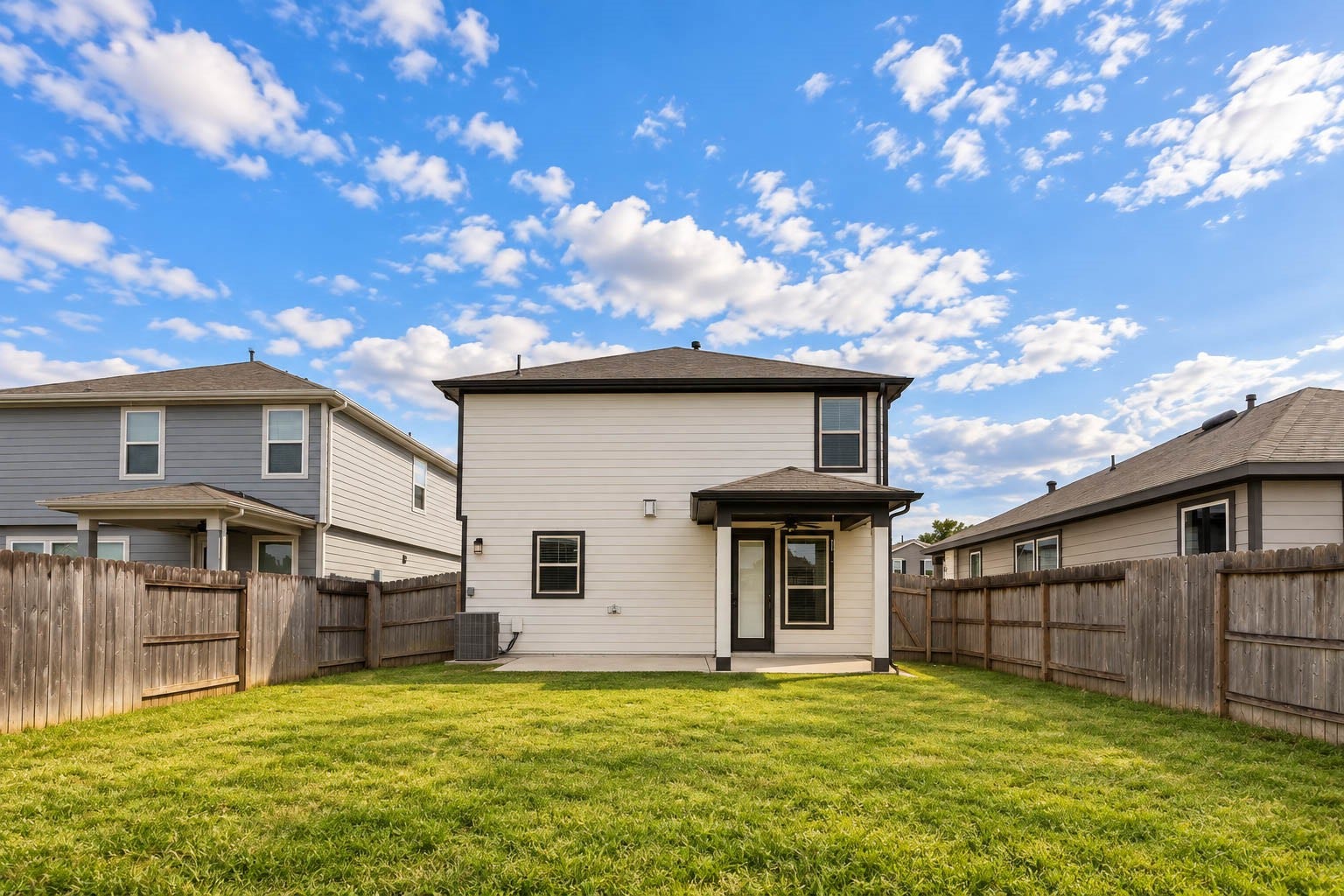 6131 Morning Fern Lane, Humble, TX 77338 This beautiful view from the rear property line showcases the home's attractive two-story exterior, spacious covered patio, & expansive grassy backyard, offering a wonderful setting for outdoor relaxation & entertaining.