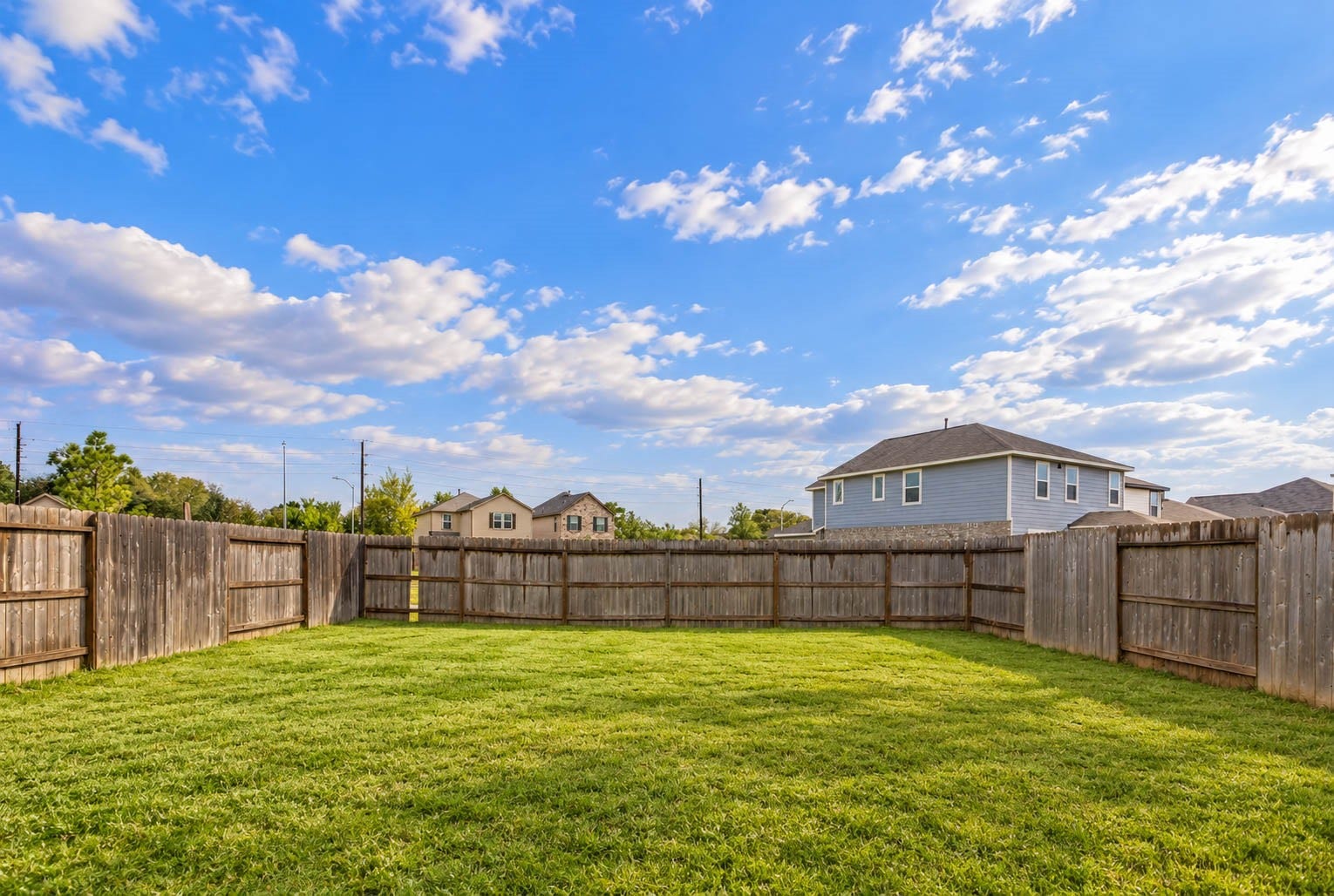 6131 Morning Fern Lane, Humble, TX 77338 Step outside to discover this spacious, fully fenced backyard offering an expansive grassy lawn with plenty of room for creating your own personalized outdoor retreat!
