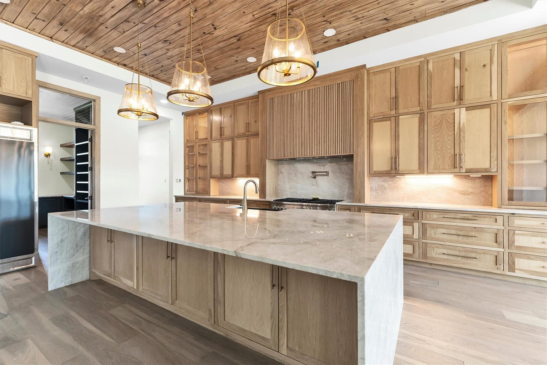 23701 Birch Grove Road, Montgomery, TX 77316 An expansive 11-foot kitchen island with sleek under-counter storage offers both style and functionality for culinary enthusiasts.