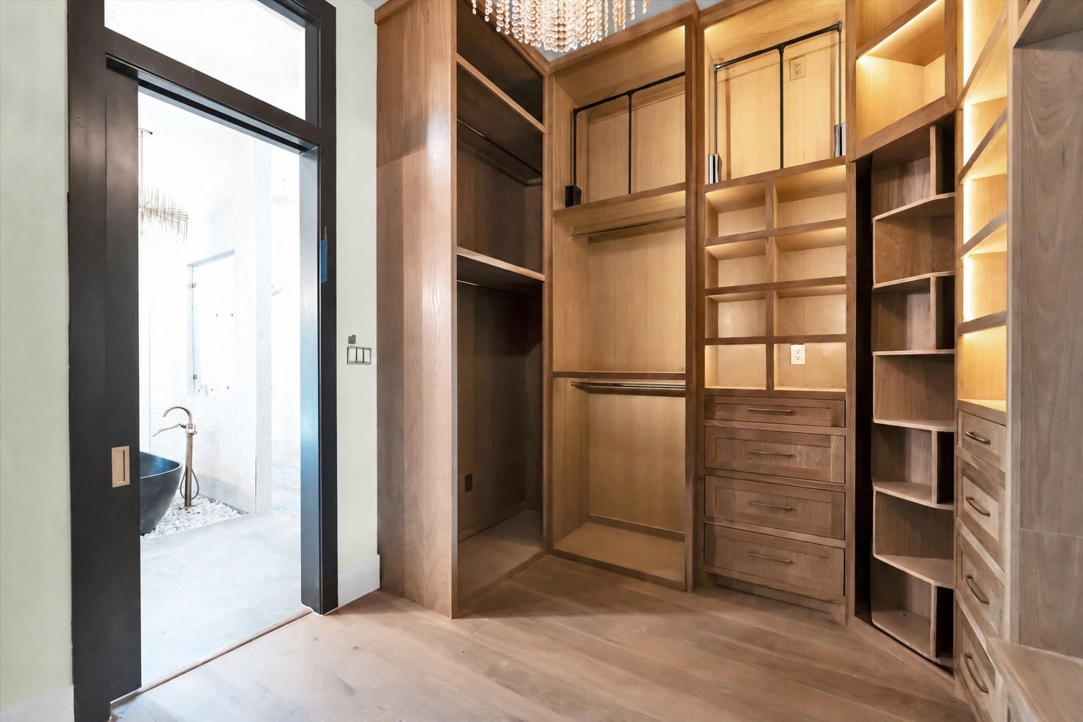 23701 Birch Grove Road, Montgomery, TX 77316 Experience luxury with this stunning main closet, crafted entirely from elegant white oak, offering ample storage and sophistication.