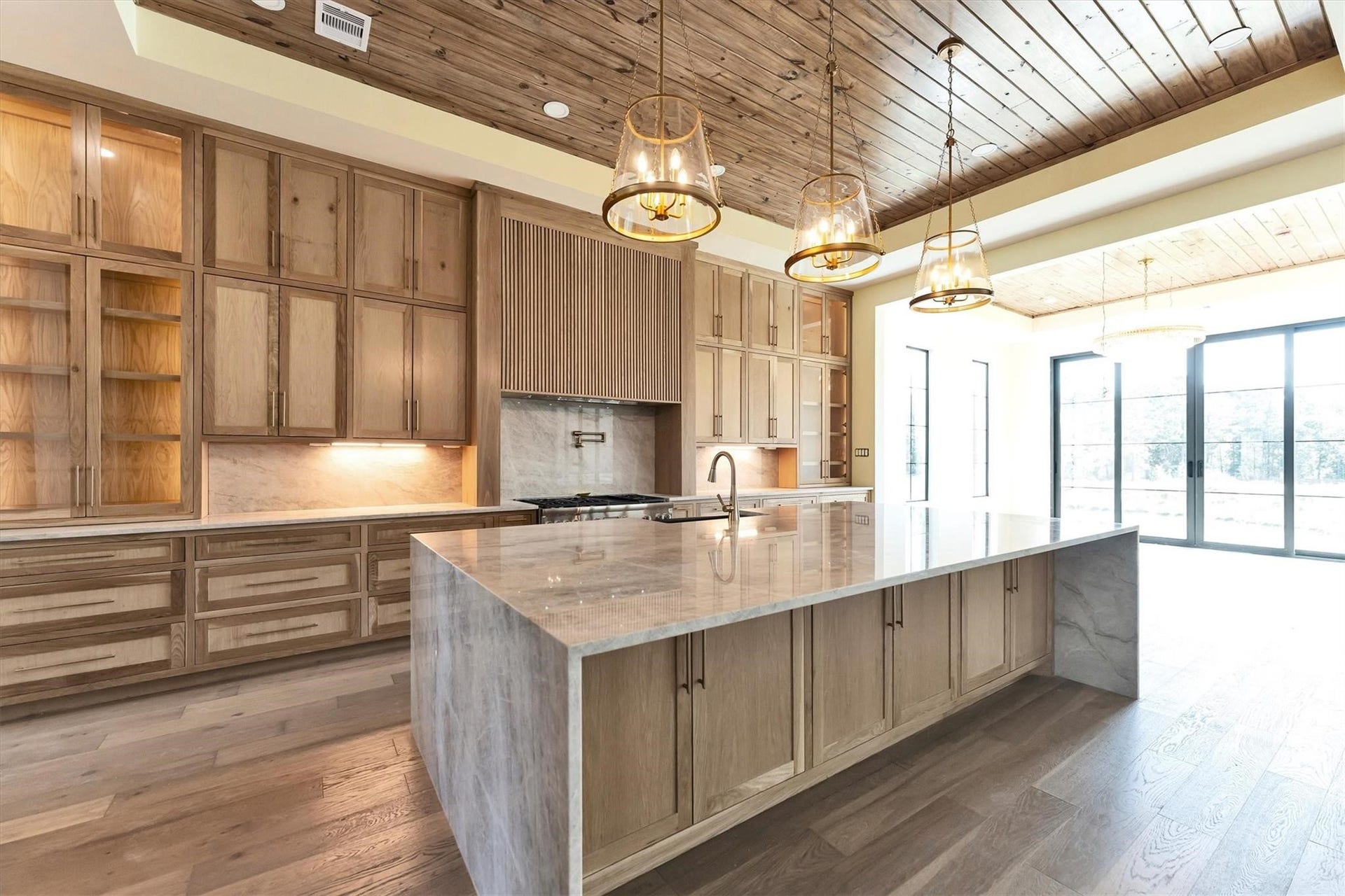 23701 Birch Grove Road, Montgomery, TX 77316 Experience luxury living with the stunning Taj Mahal Quartzite countertops, creating an elegant focal point in this spacious, light-filled kitchen.