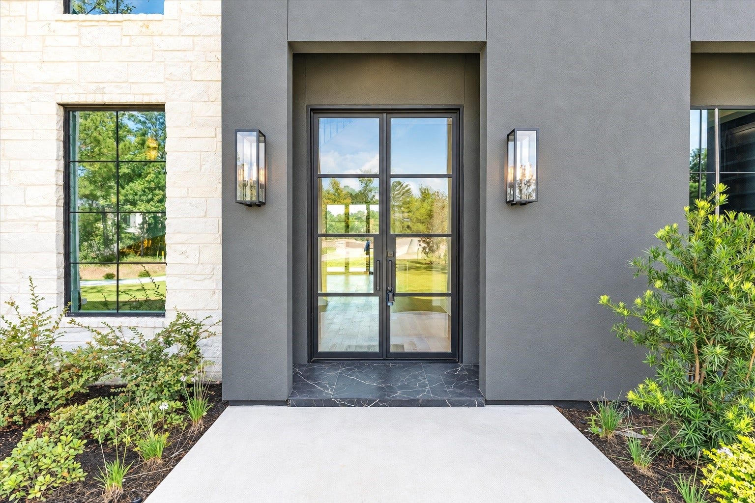 23701 Birch Grove Road, Montgomery, TX 77316 Striking stucco facade complemented by a grand 10-foot metal door exudes modern elegance.