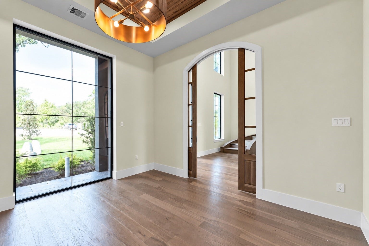 23701 Birch Grove Road, Montgomery, TX 77316 Elegant study just off the entrance, featuring a stunning front garden view through expansive windows.