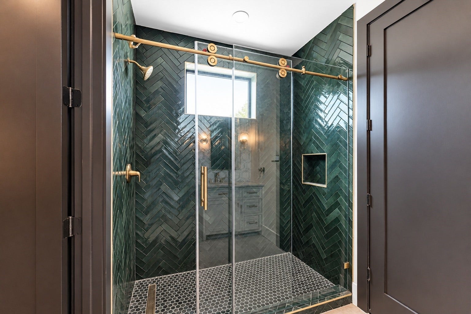 23701 Birch Grove Road, Montgomery, TX 77316 Step into luxury with a stunning herringbone tile design that elevates this modern shower, complemented by sleek gold fixtures for an elegant touch.