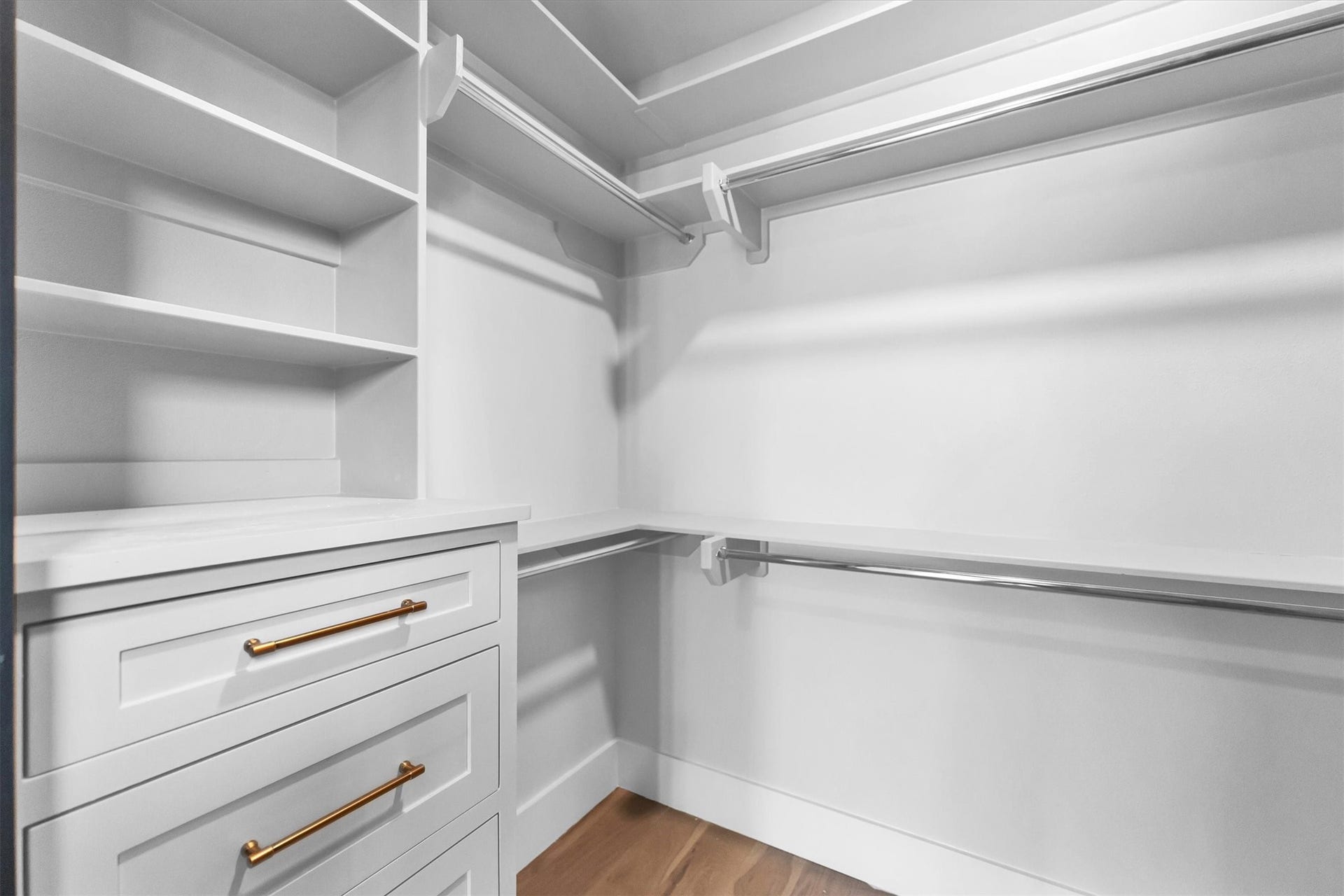 23701 Birch Grove Road, Montgomery, TX 77316 Spacious walk-in closet featuring custom shelving, ample hanging space, and elegant brass hardware for a touch of luxury.