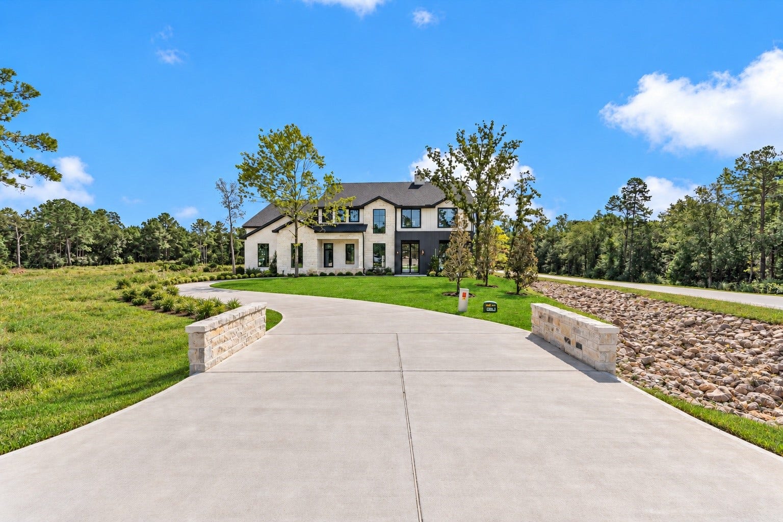 23701 Birch Grove Road, Montgomery, TX 77316 Experience the perfect blend of elegance and charm with a stunning exterior featuring stone, stucco, and board & batten elements, all set within a lush, inviting landscape.