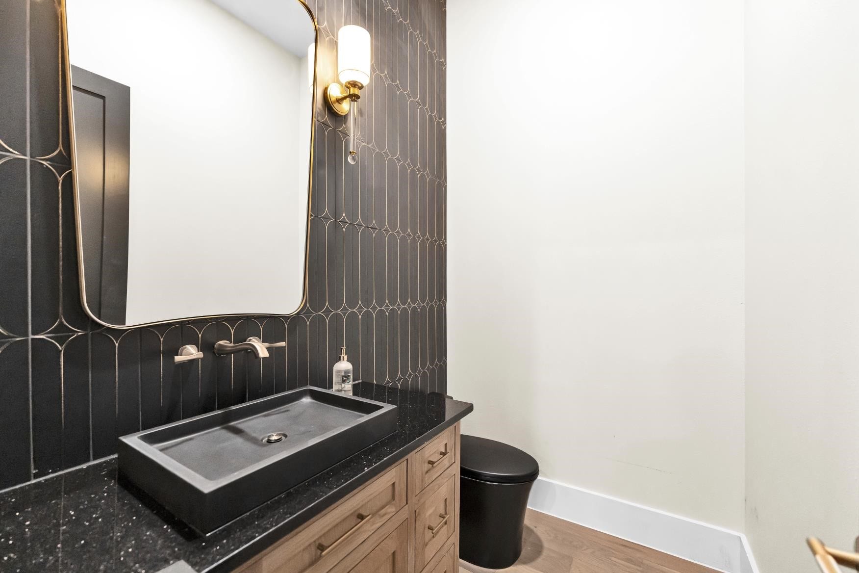 23701 Birch Grove Road, Montgomery, TX 77316 Discover elegance in the first-floor powder room, featuring exquisite custom cabinetry crafted from white oak.