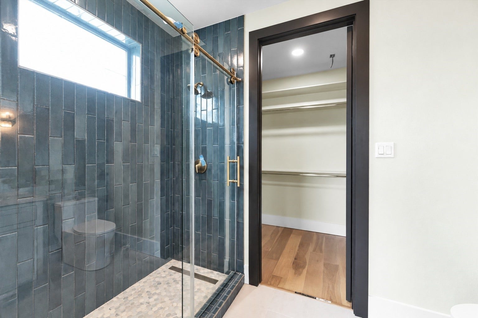 23701 Birch Grove Road, Montgomery, TX 77316 Experience the luxury of a shower bathed in natural light, featuring elegant floor-to-ceiling tile.