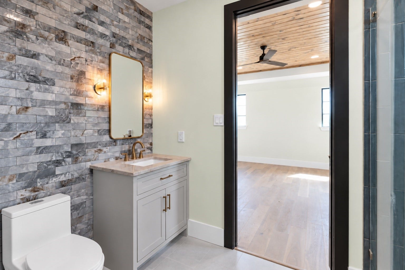 23701 Birch Grove Road, Montgomery, TX 77316 The fourth bedroom boasts a stylish private bathroom featuring a sleek vanity and elegant tiled walls, offering a perfect blend of comfort and modern aesthetics.