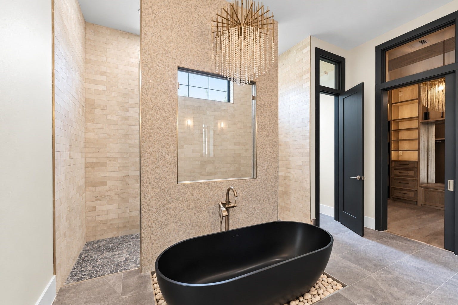 23701 Birch Grove Road, Montgomery, TX 77316 Experience ultimate luxury with a stunning freestanding bathtub, complemented by a high-end spiller and a sophisticated chandelier above.