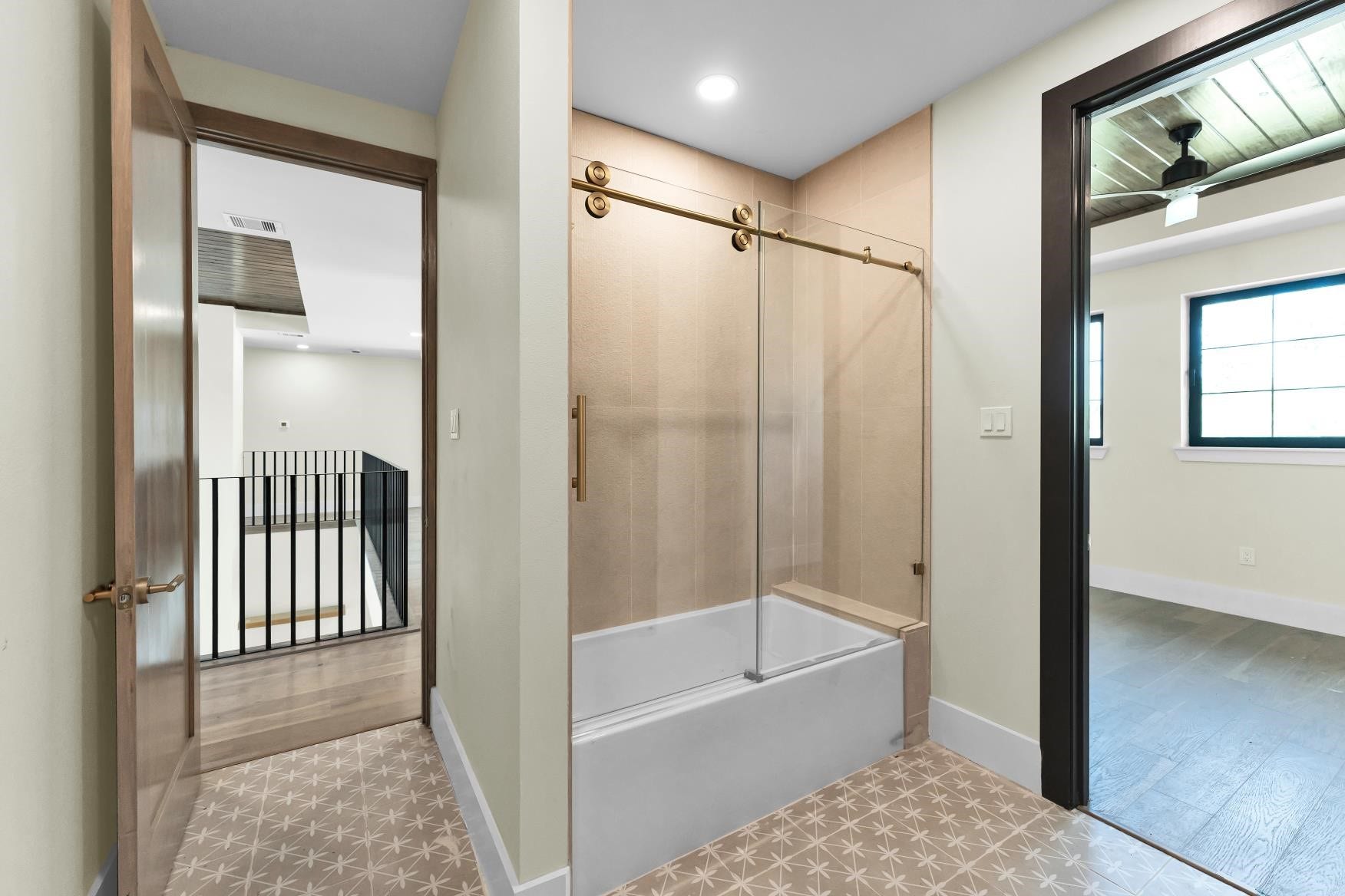 23701 Birch Grove Road, Montgomery, TX 77316 Indulge in a luxurious bath experience with this elegantly tiled bathtub, extending seamlessly to the ceiling for a sophisticated touch.