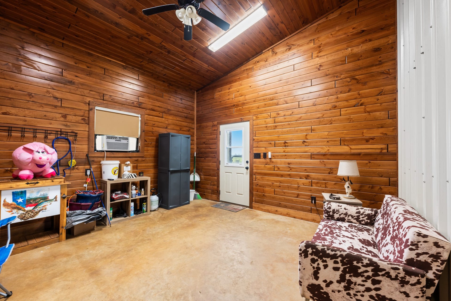 A great addition to any livestock property! This dedicated tack and show room offers a comfortable space to organize riding gear, store supplies, and unwind after a day spent outdoors.