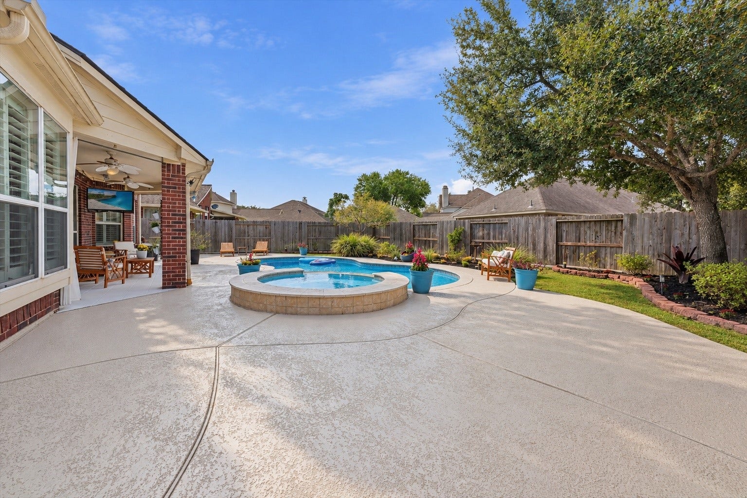 Large spacious backyard area with green space behind for pets