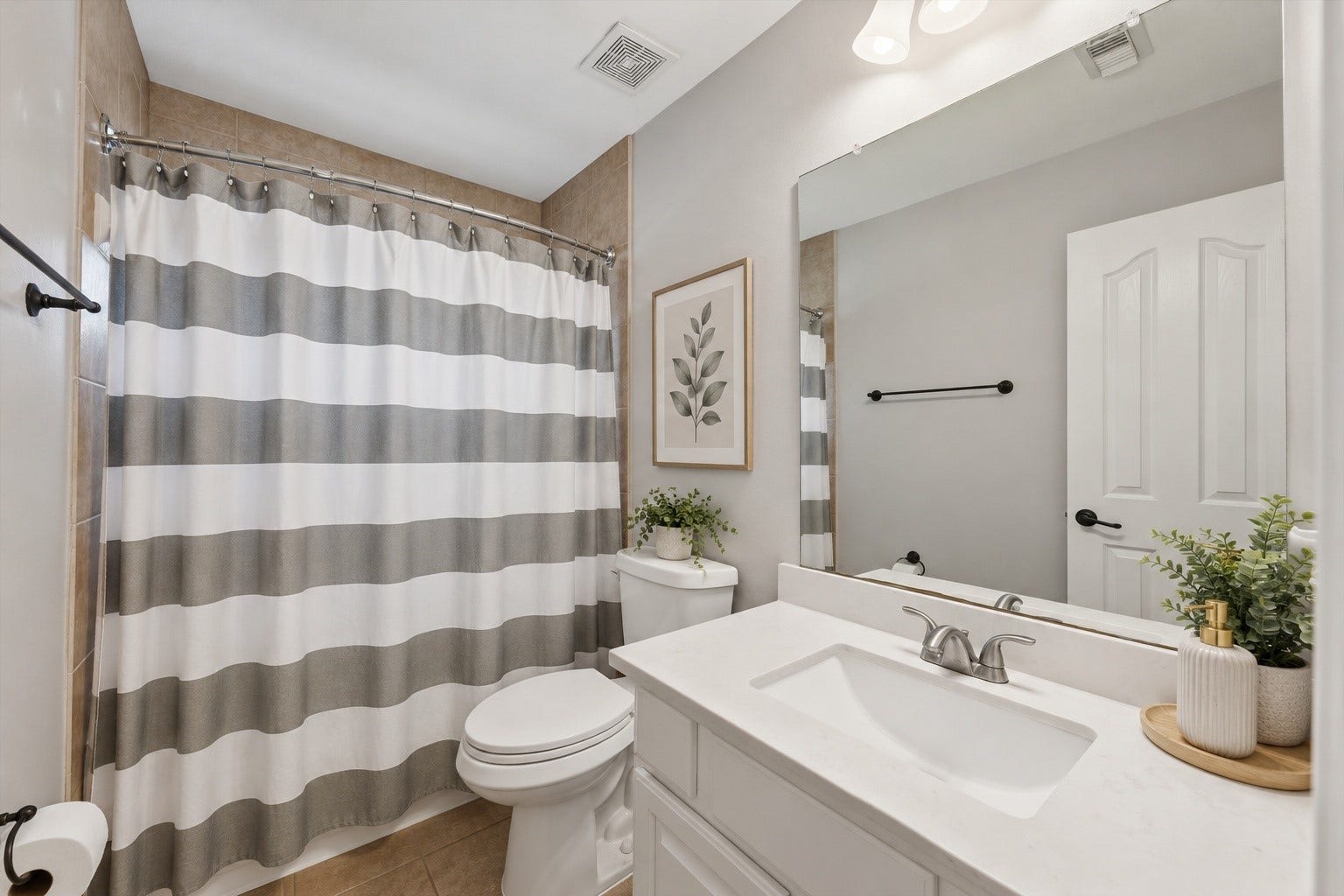 Secondary full bathroom upstairs next to gameroom.  This bathroom has been lightly digitally staged.