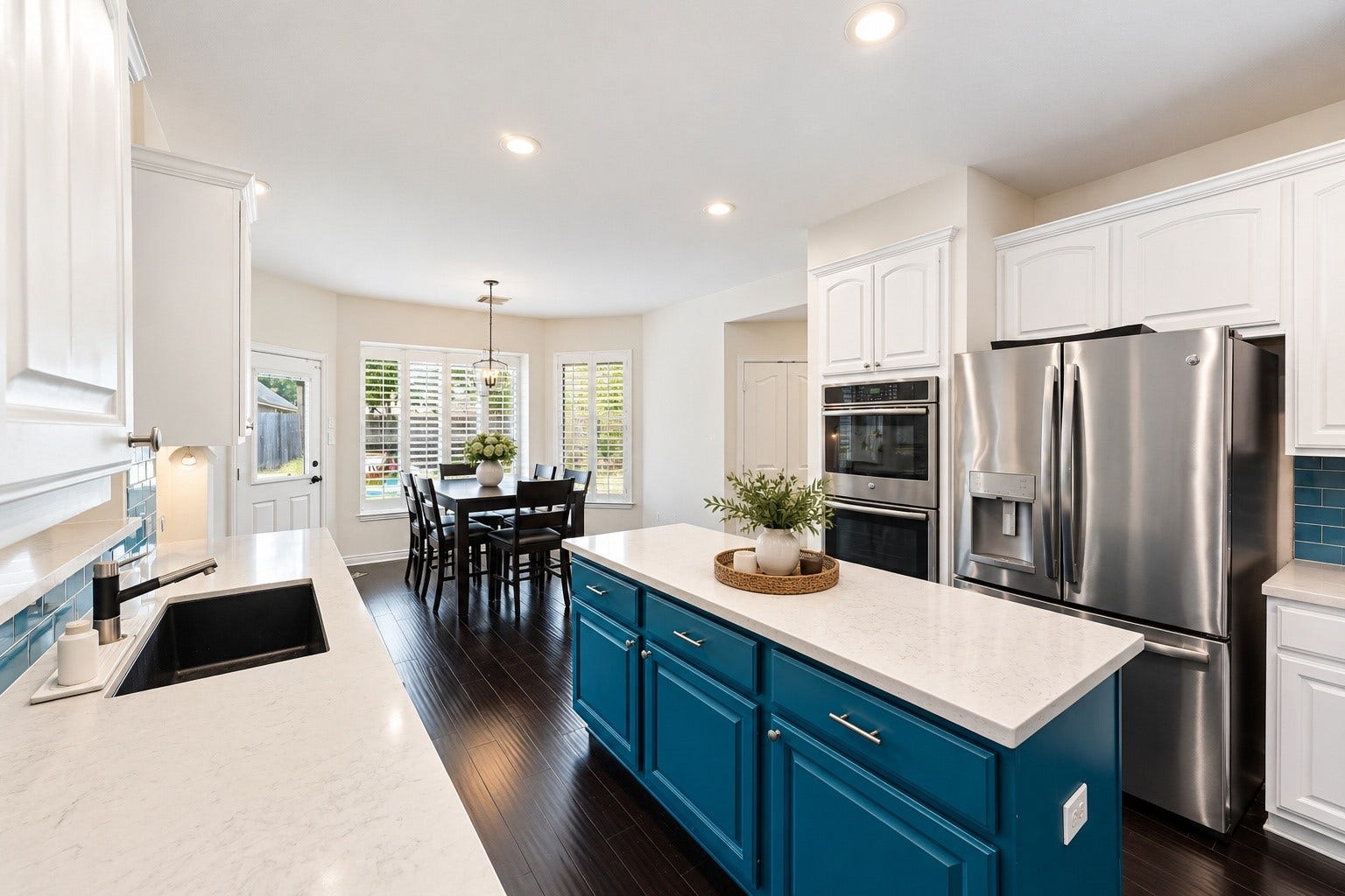 Kitchen open to breakfast area.  Kitchen and dining area have been lightly digitally staged.