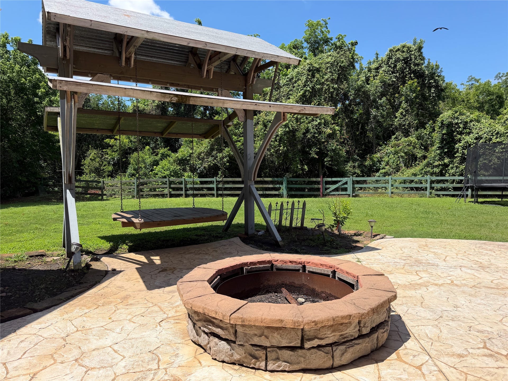5119 Water Oak Crescent, Fulshear, TX 77441 ackyard oasis! Massive covered patio with stone pillars, stamped concrete extension, built-in fire pit, and plenty of green space to entertain.
