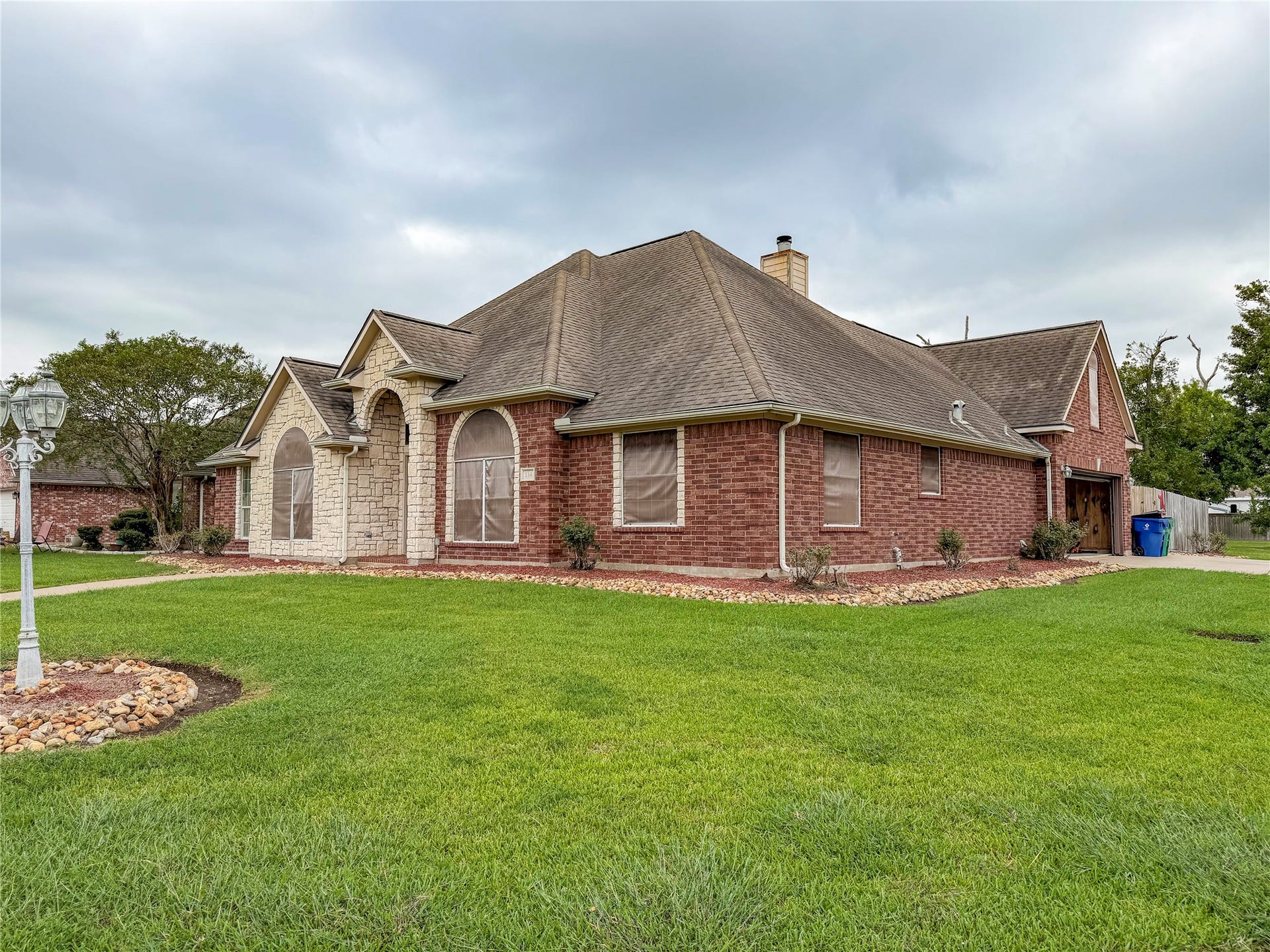134 Dove Trail, Richwood, TX 77531 Front view of the property highlighting the homes attractive exterior, driveway, and well-maintained outdoor space.