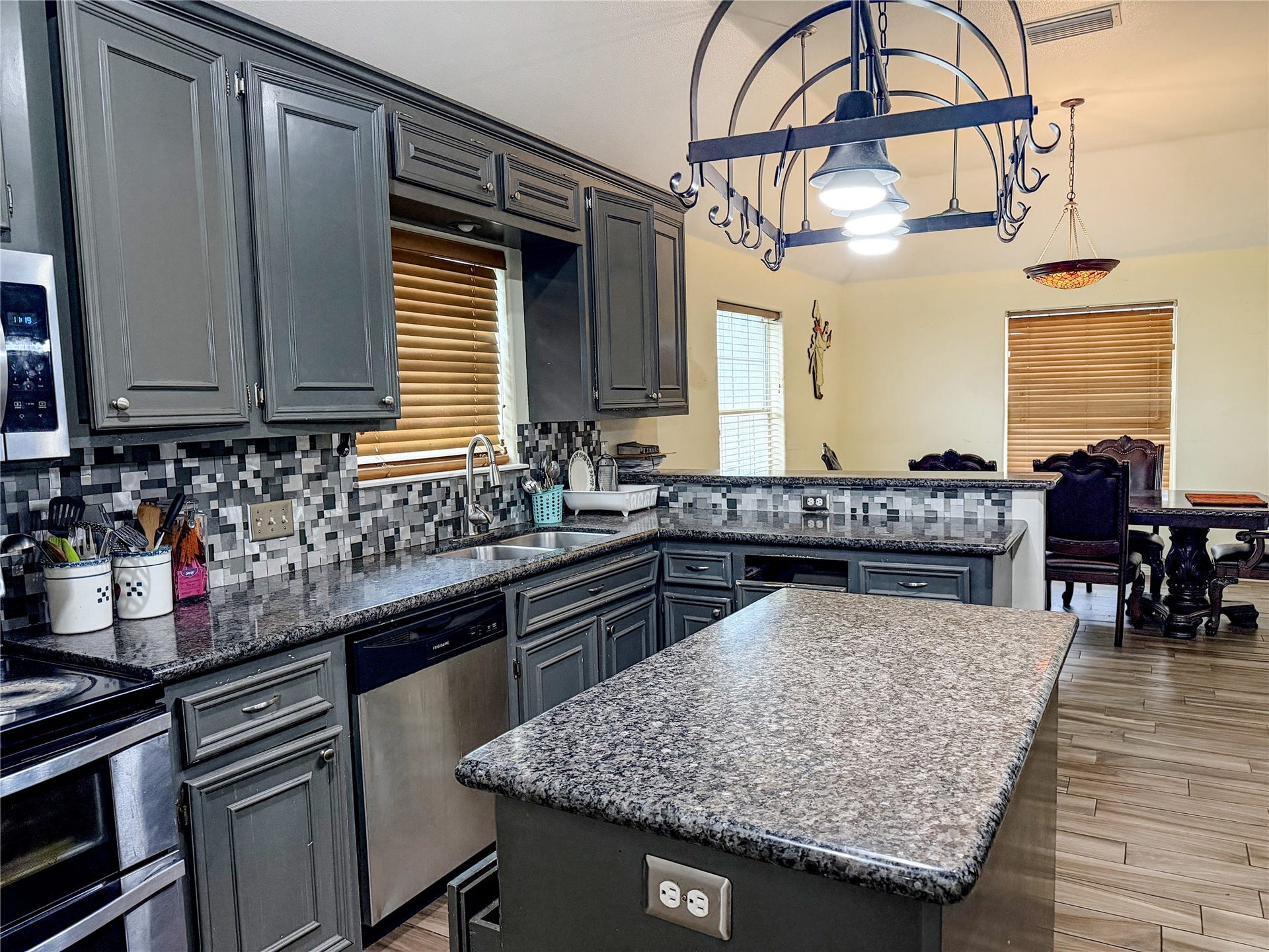 134 Dove Trail, Richwood, TX 77531 Bright kitchen with plenty of storage, expansive countertops, and convenient workspace for meal preparation.